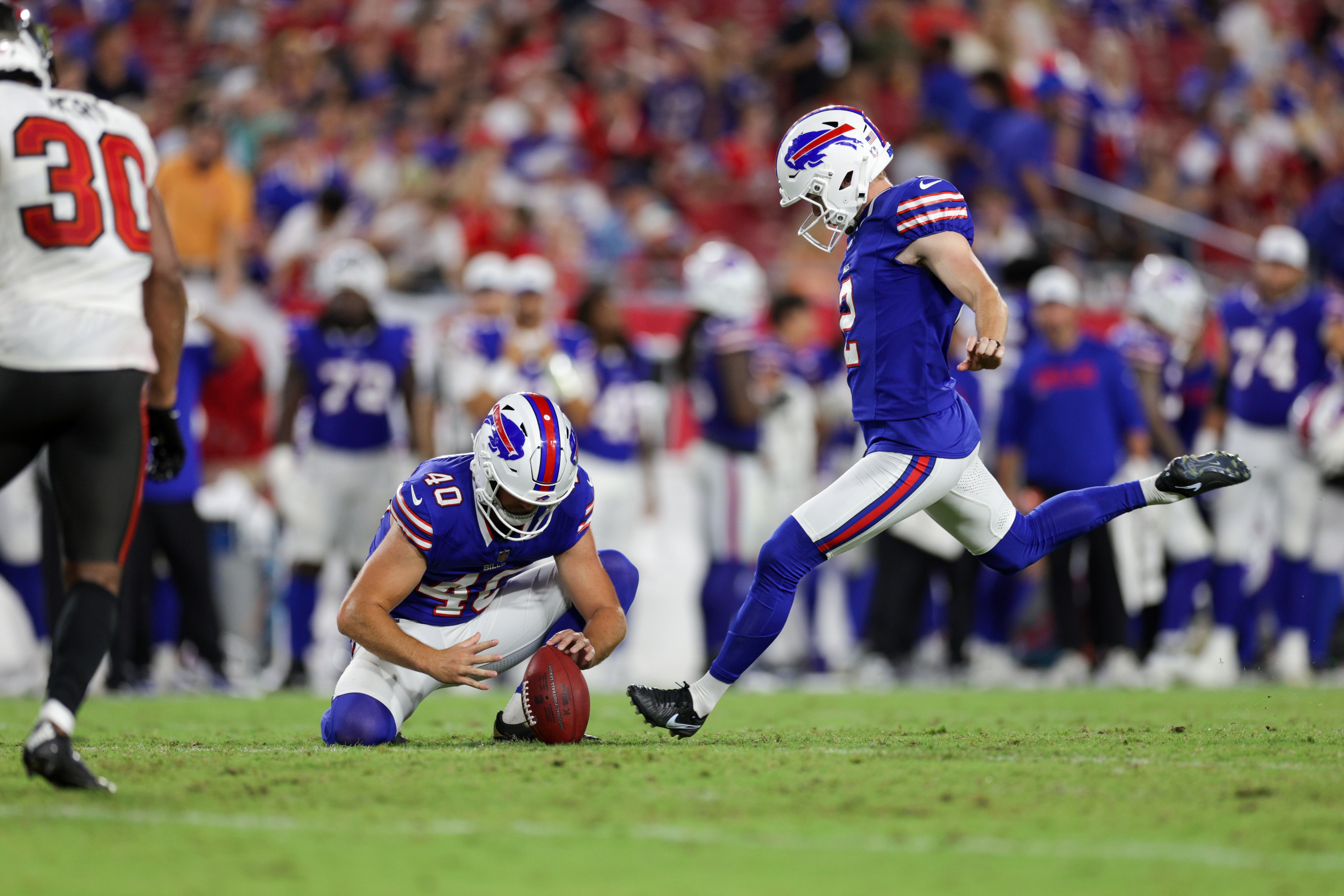 Aug 23, 2025; Tampa, Florida, USA; Buffalo Bills place kicker Tyler Bass (2) attempts a field goal held by Buffalo Bills punter Brad Robbins (40) against the Tampa Bay Buccaneers in the fourth quarter at Raymond James Stadium.