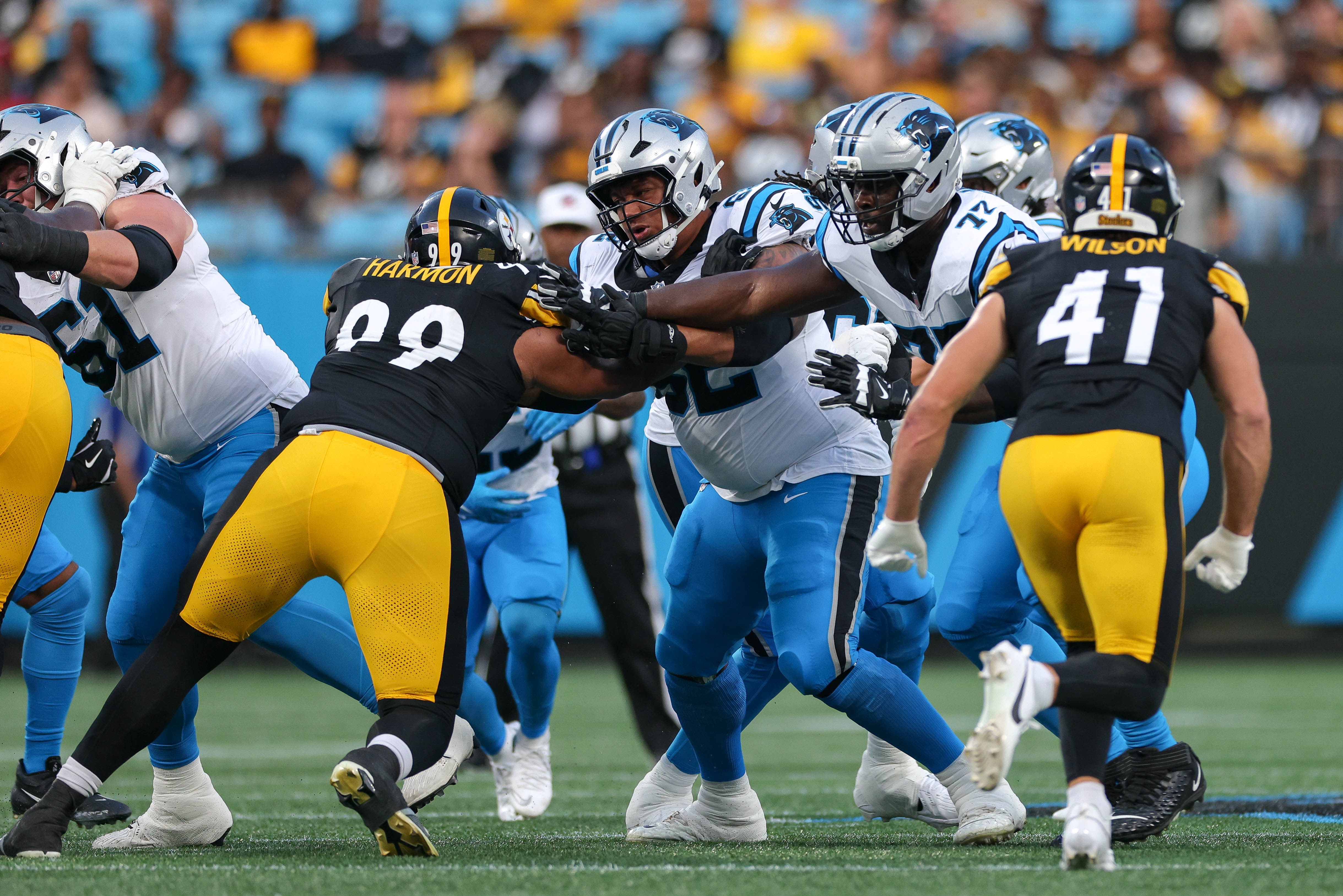 Aug 21, 2025; Charlotte, North Carolina, USA; Carolina Panthers tackle Taylor Moton (72) and guard Chandler Zavala (62) block Pittsburgh Steelers defensive tackle Derrick Harmon (99) during the first quarter at Bank of America Stadium.