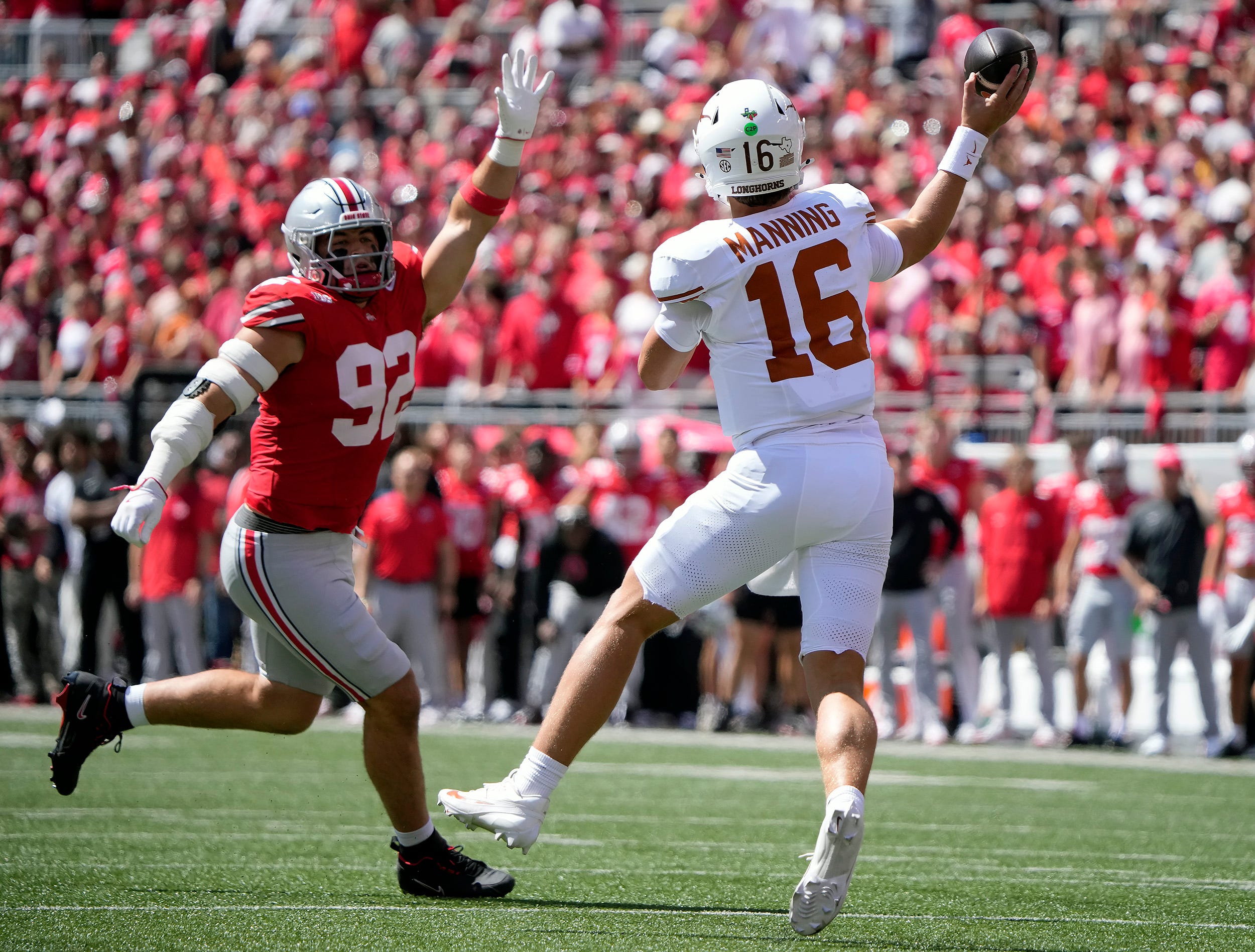 Texas Longhorns quarterback Arch Manning (16) throws the ball against Ohio State Buckeyes defensive end Caden Curry (92) in the first quarter of their game at Ohio Stadium in Columbus, Ohio on Aug 30, 2025.