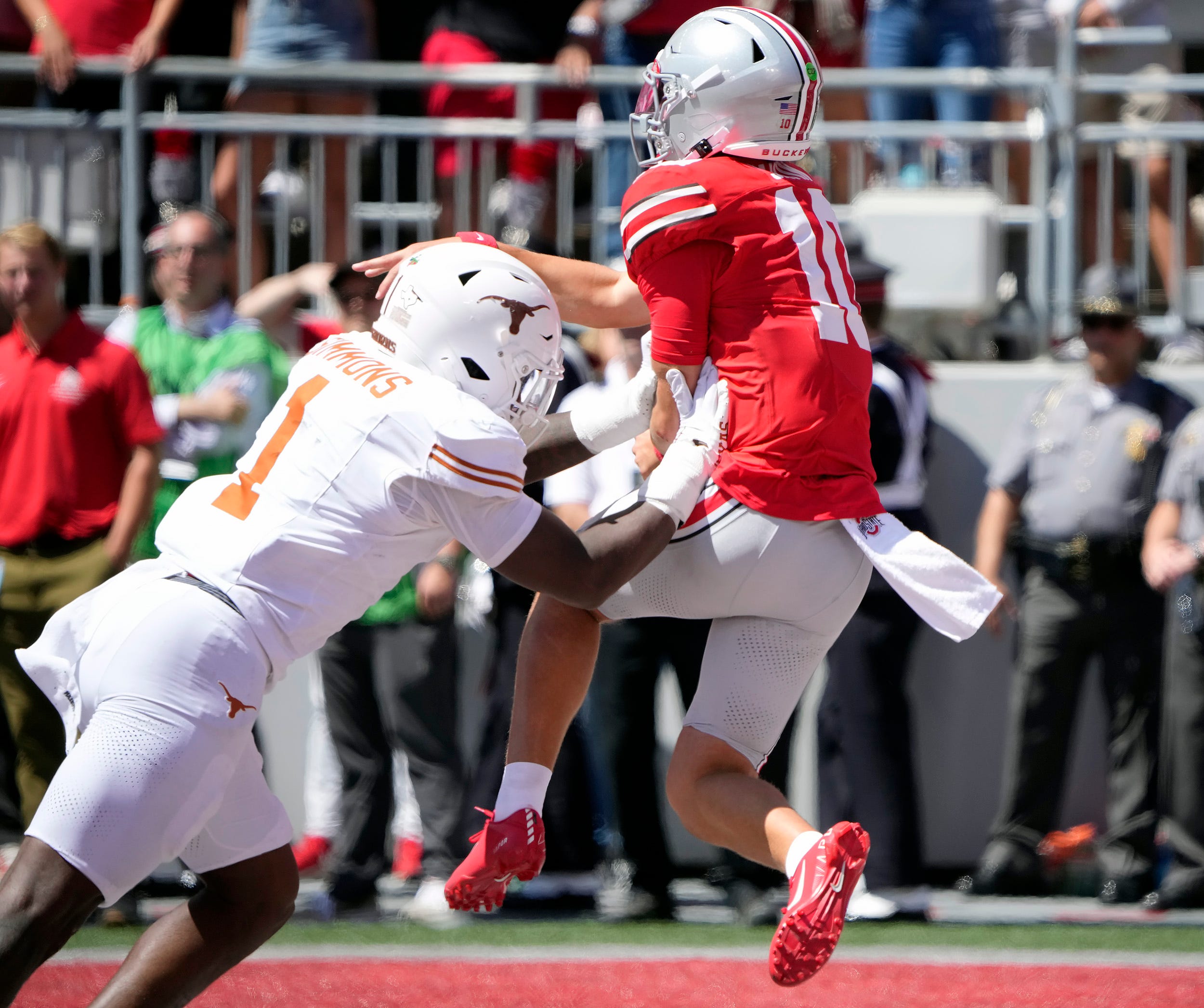 Ohio State Buckeyes quarterback Julian Sayin (10) throws the ball against Texas Longhorns linebacker Colin Simmons (1) in the second quarter of their game at Ohio Stadium in Columbus, Ohio on Aug 30, 2025.