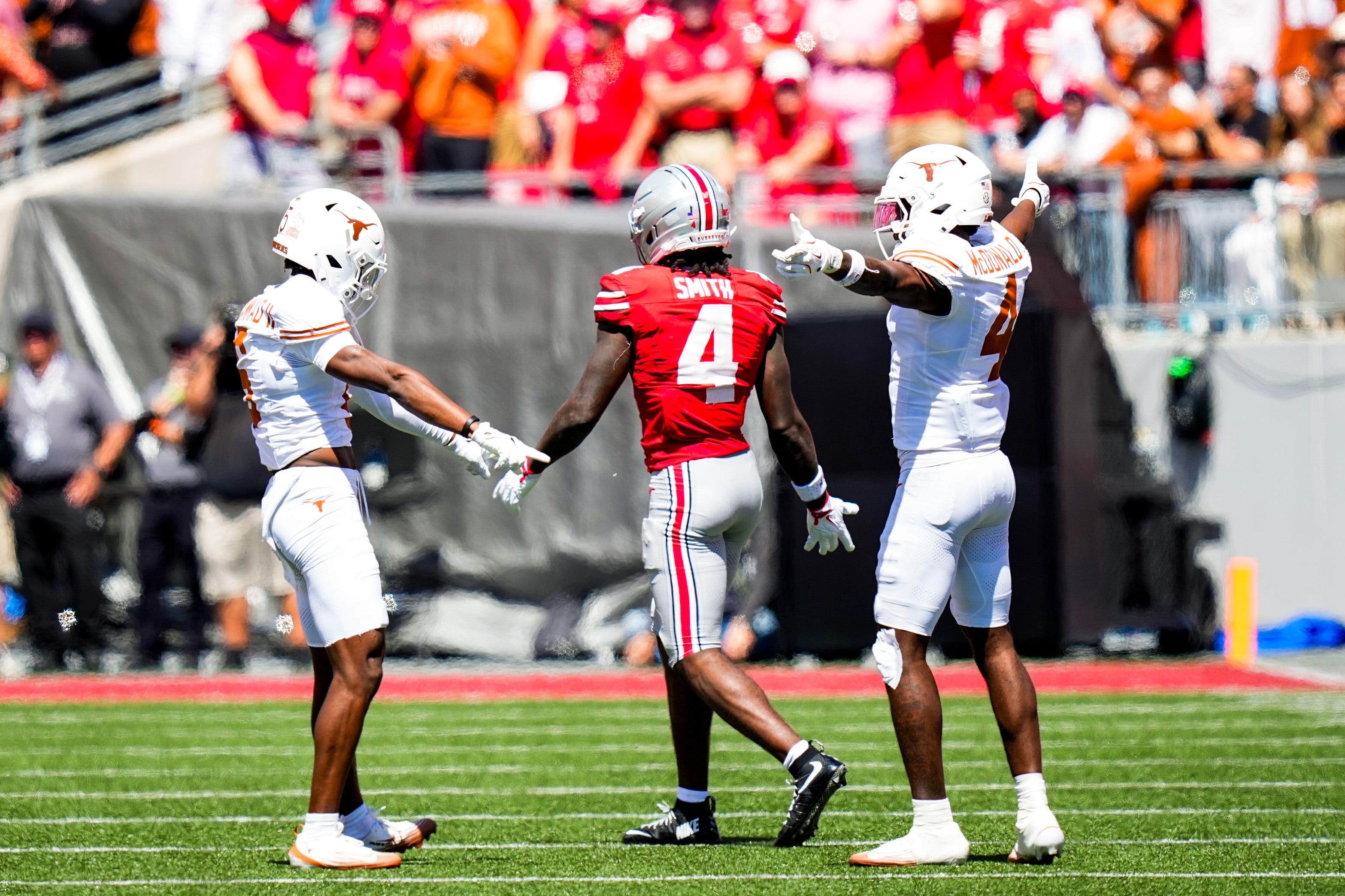 Texas Longhorns defensive back Malik Muhammad (5) and defensive back Jelani McDonald (4) react after Ohio State Buckeyes wide receiver Jeremiah Smith (4) dropped a pass in the second half at Ohio Stadium on Saturday, Aug. 30, 2025 in Columbus, Ohio.