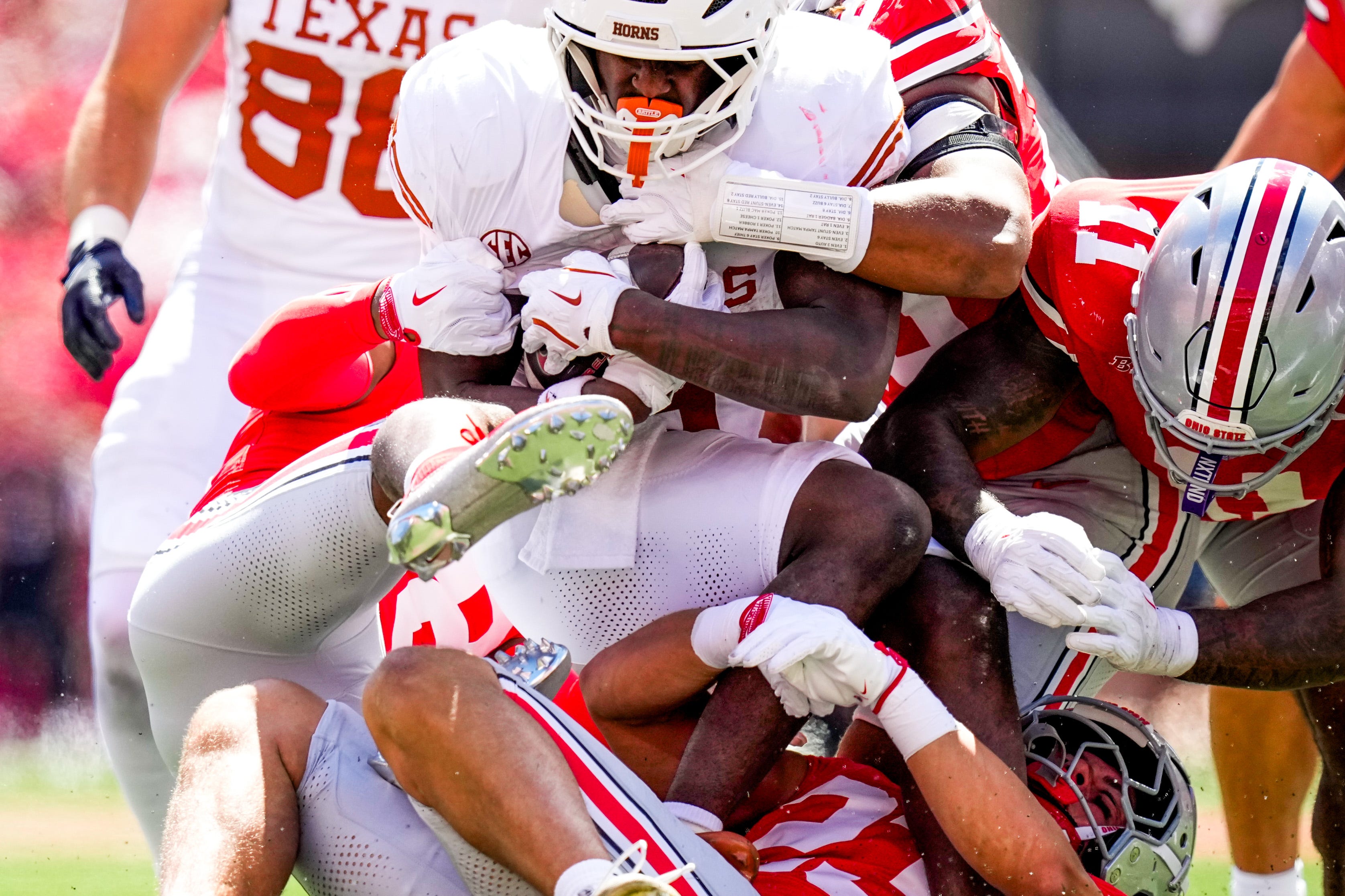 Texas Longhorns running back Quintrevion Wisner (5) is tackled Ohio State Buckeyes linebacker Garrett Stover (23) and safety Leroy Roker III (28) in the second half at Ohio Stadium on Saturday, Aug. 30, 2025 in Columbus, Ohio.
