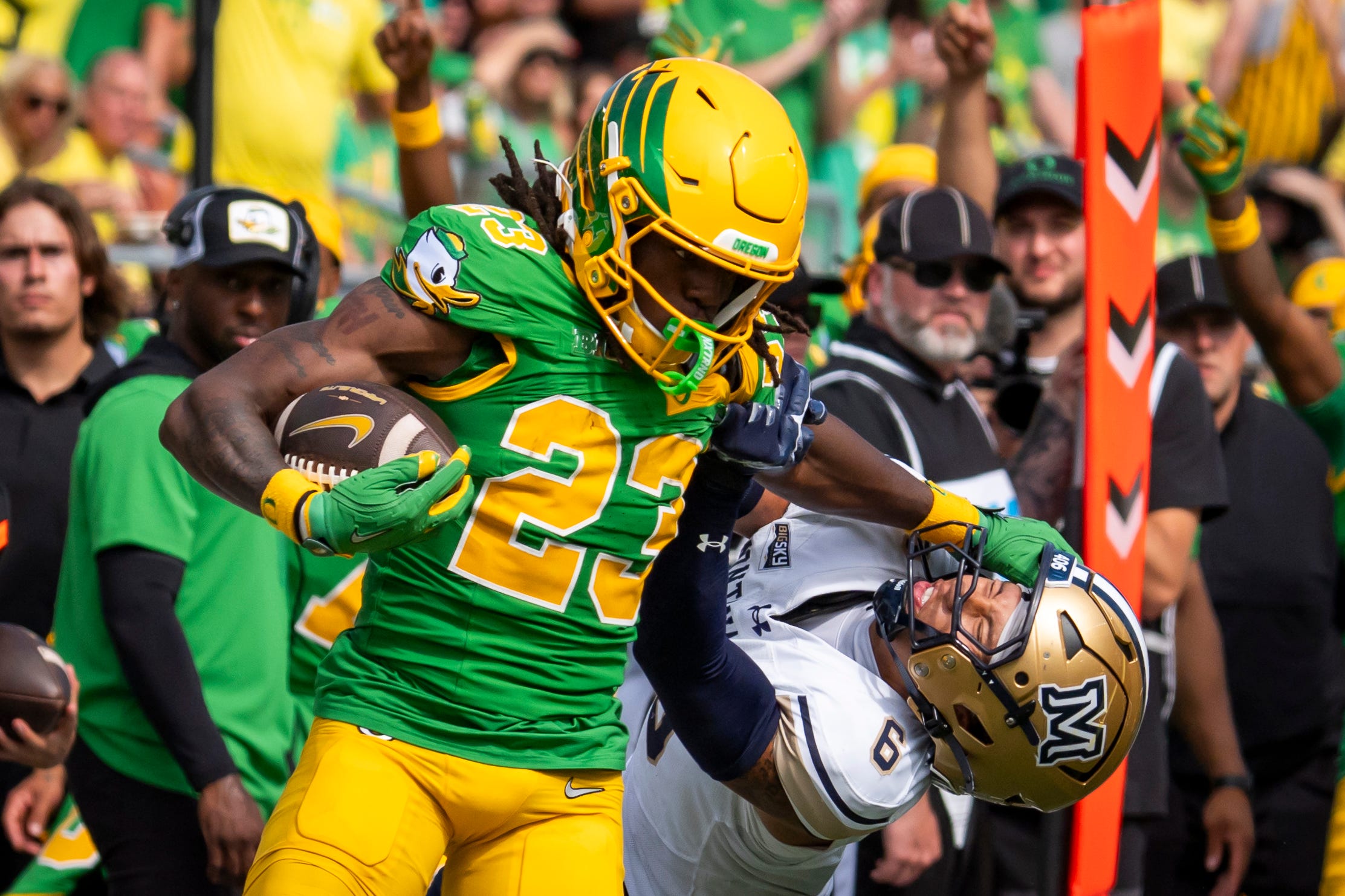 Oregon running back Dierre Hill Jr. attempts to break a tackle by Montana State defensive back Bryant Meredith as the Oregon Ducks host the Montana State Bobcats on Aug. 30, 2025, at Autzen Stadium in Eugene, Oregon.