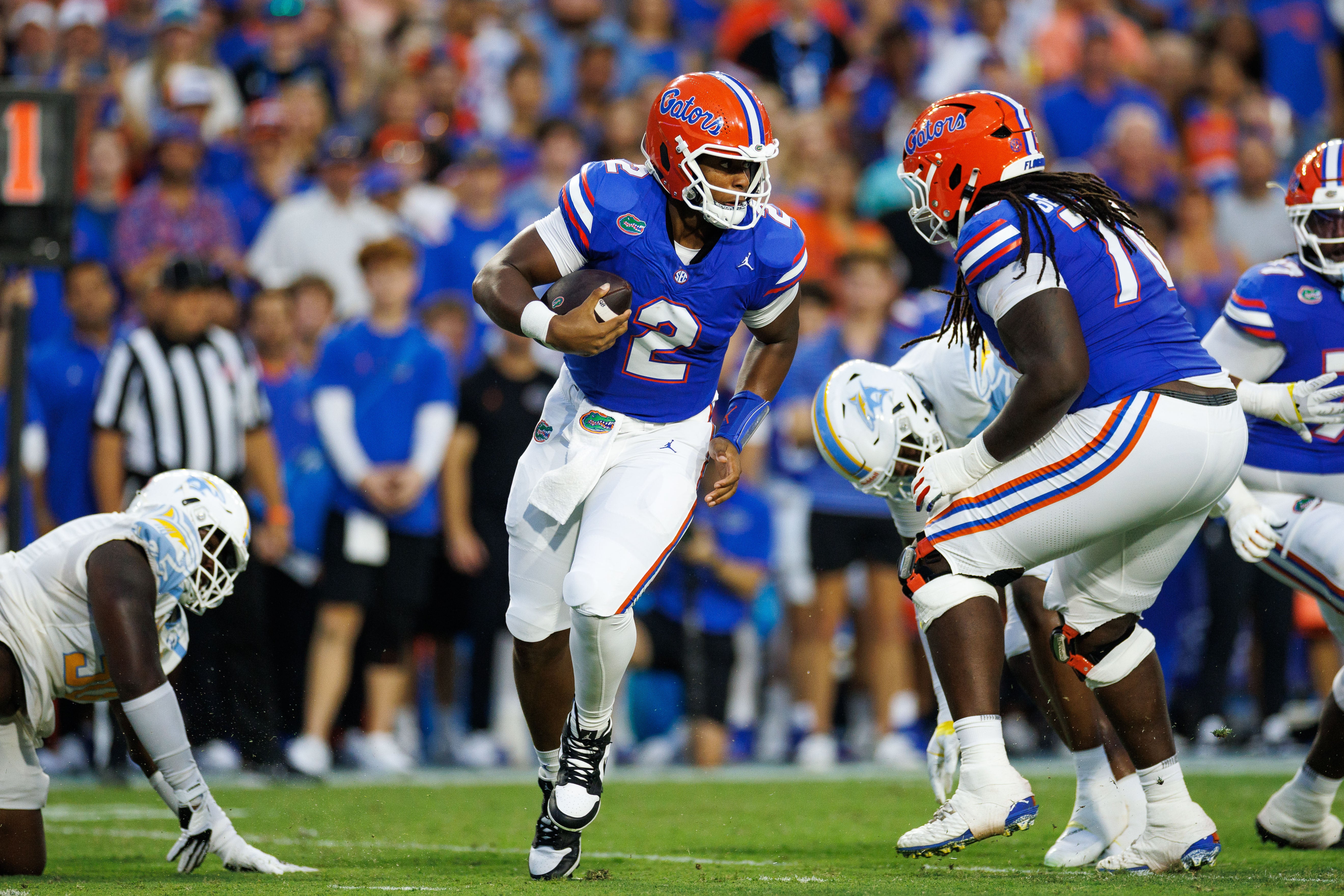 Aug 30, 2025; Gainesville, Florida, USA; Florida Gators quarterback DJ Lagway (2) breaks a tackle against the Long Island Sharks during the first half at Ben Hill Griffin Stadium.