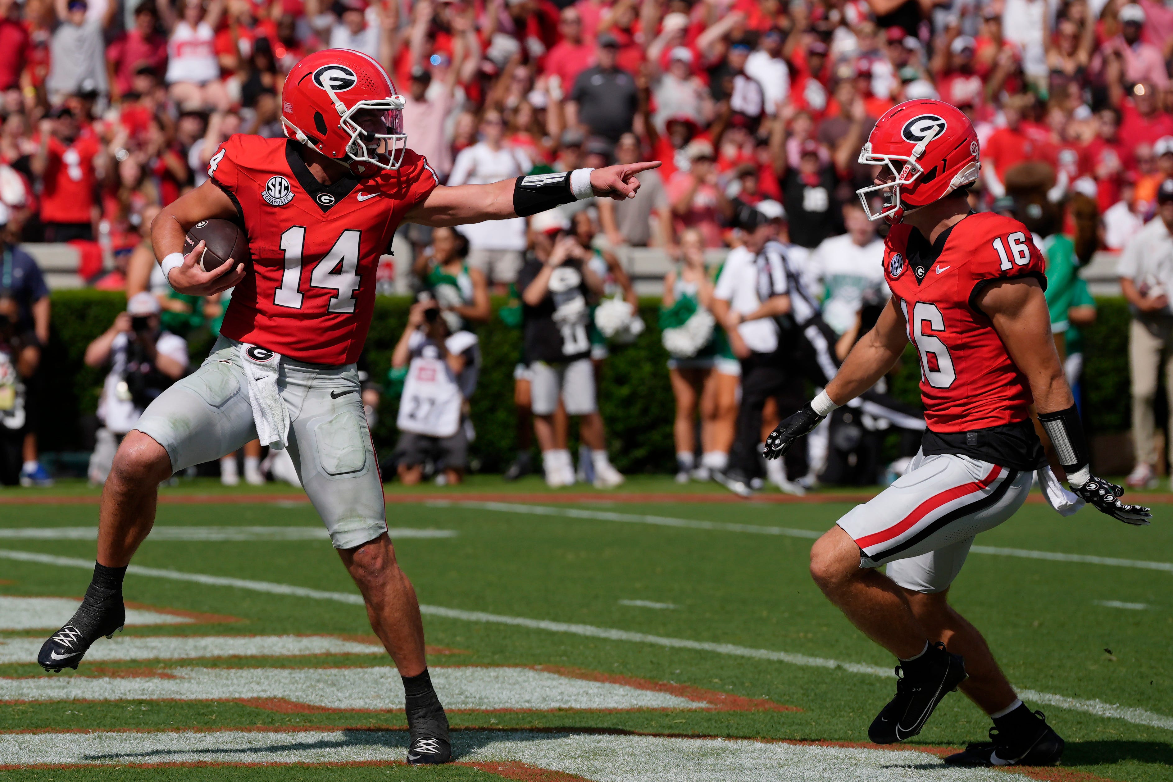 Georgia quarterback Gunner Stockton (14) celebrates with Georgia wide receiver London Humphreys (16) while walking in for a touchdown during the first half of a NCAA college football game against Mars