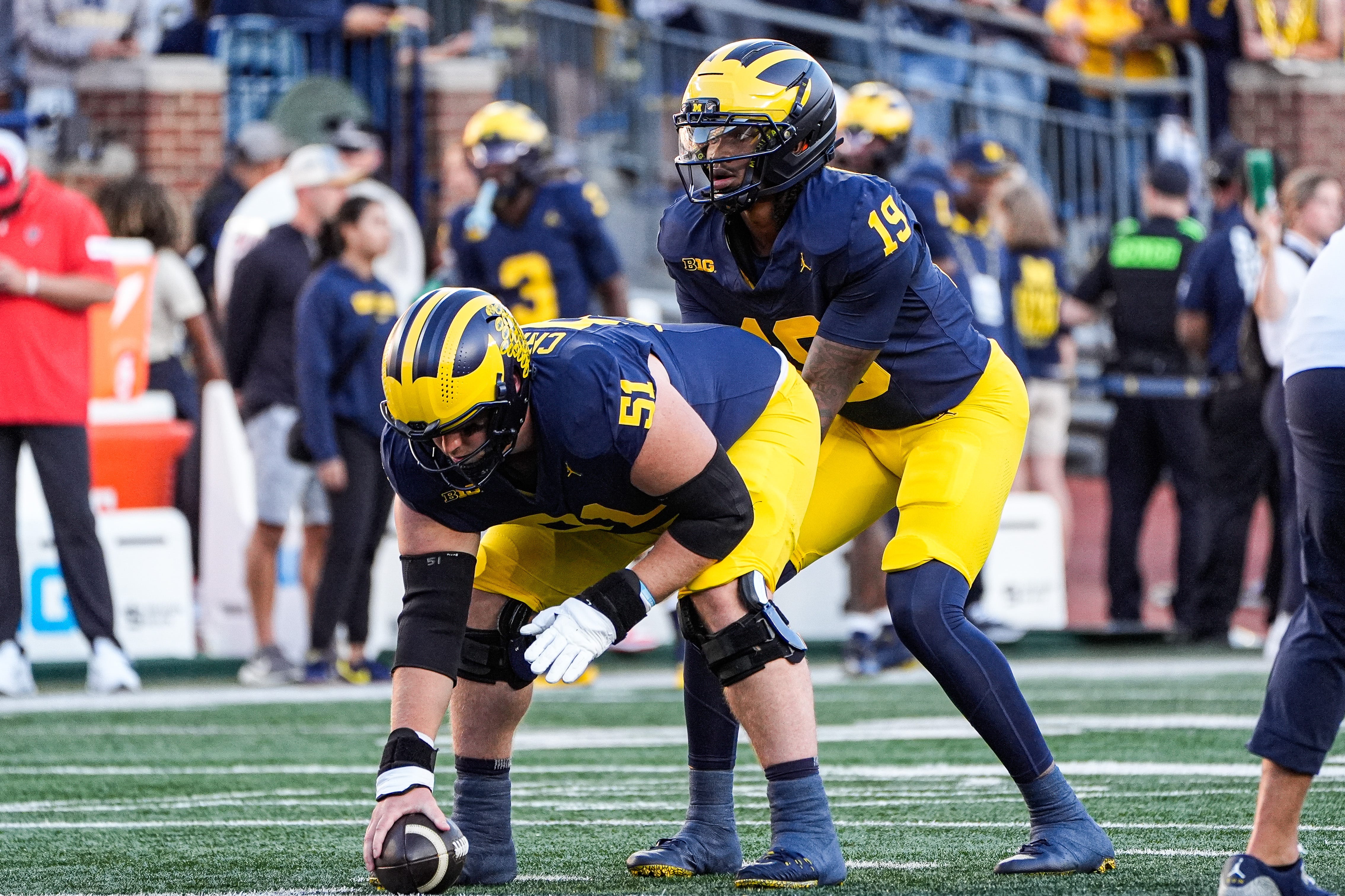 Michigan quarterback Bryce Underwood takes snaps from center Greg Crippen during warmups ahead of the New Mexico game at Michigan Stadium in Ann Arbor on Saturday, August 30, 2025.