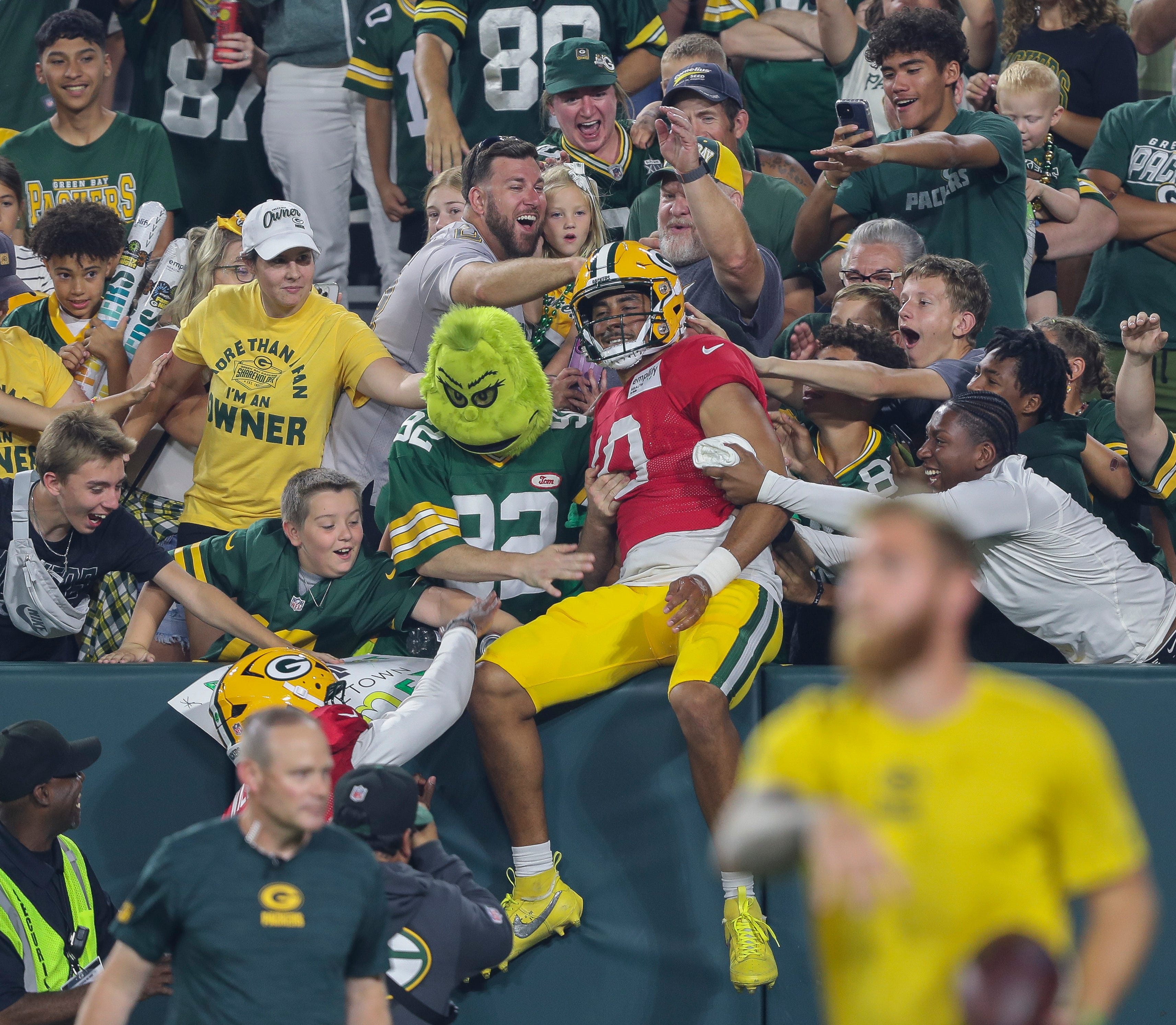 Green Bay Packers quarterback Jordan Love (10) does a Lambeau Leap after finishing a drill during Family Night on Saturday, August 2, 2025, at Lambeau Field in Green Bay, Wis.