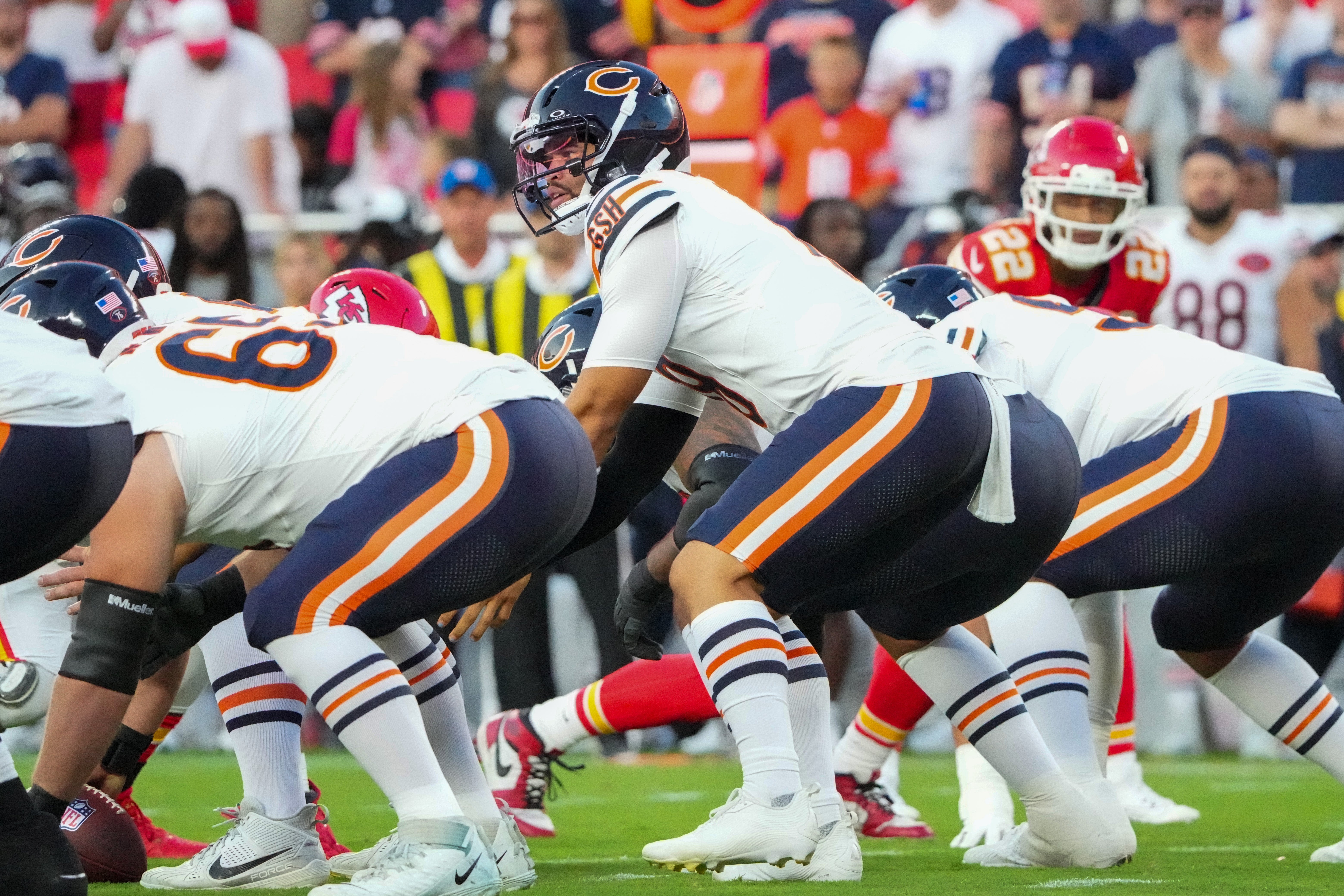 Aug 22, 2025; Kansas City, Missouri, USA; Chicago Bears quarterback Caleb Williams (18) goes under center against the Kansas City Chiefs during the game at GEHA Field at Arrowhead Stadium.