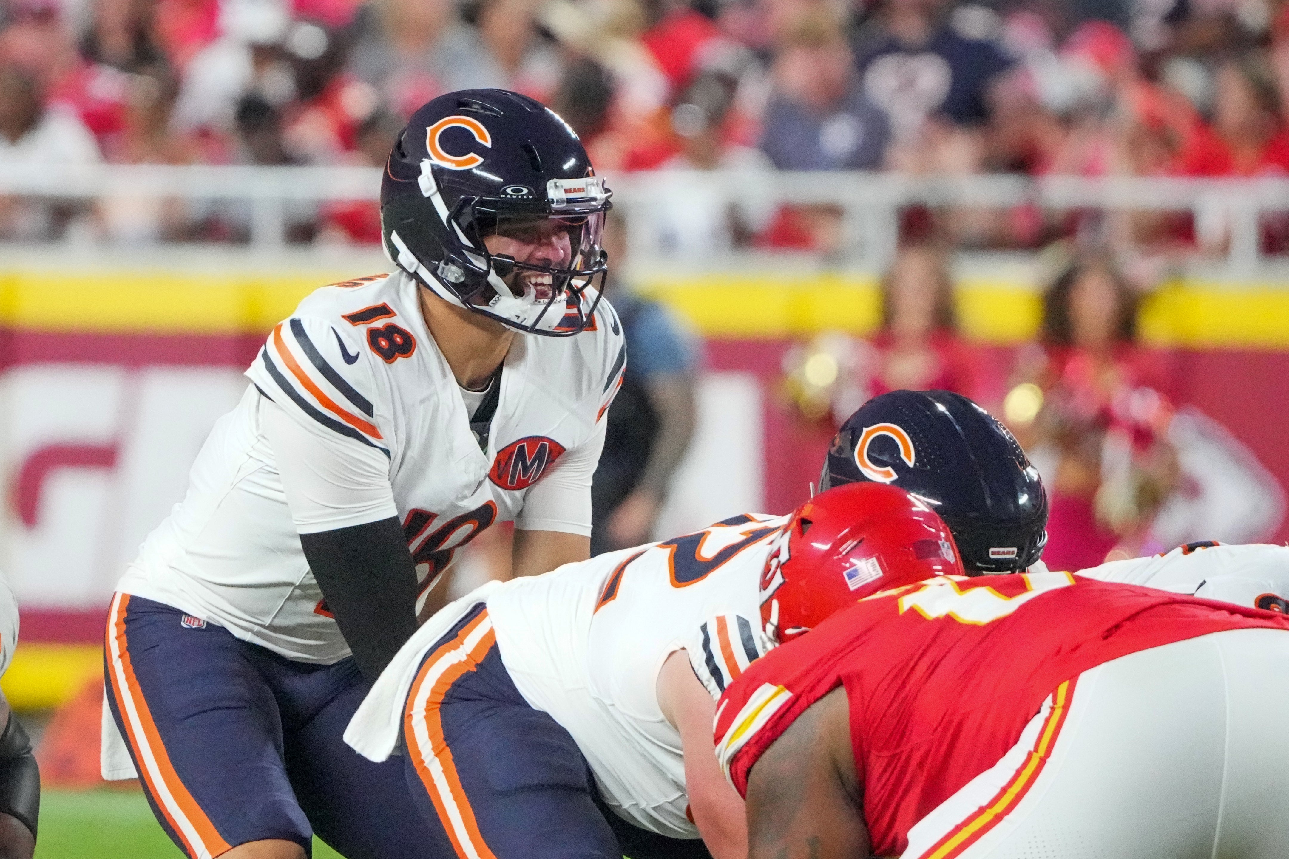 Aug 22, 2025; Kansas City, Missouri, USA; Chicago Bears quarterback Caleb Williams (18) gestures at the line against the Kansas City Chiefs during the first half of the game at GEHA Field at Arrowhead Stadium.