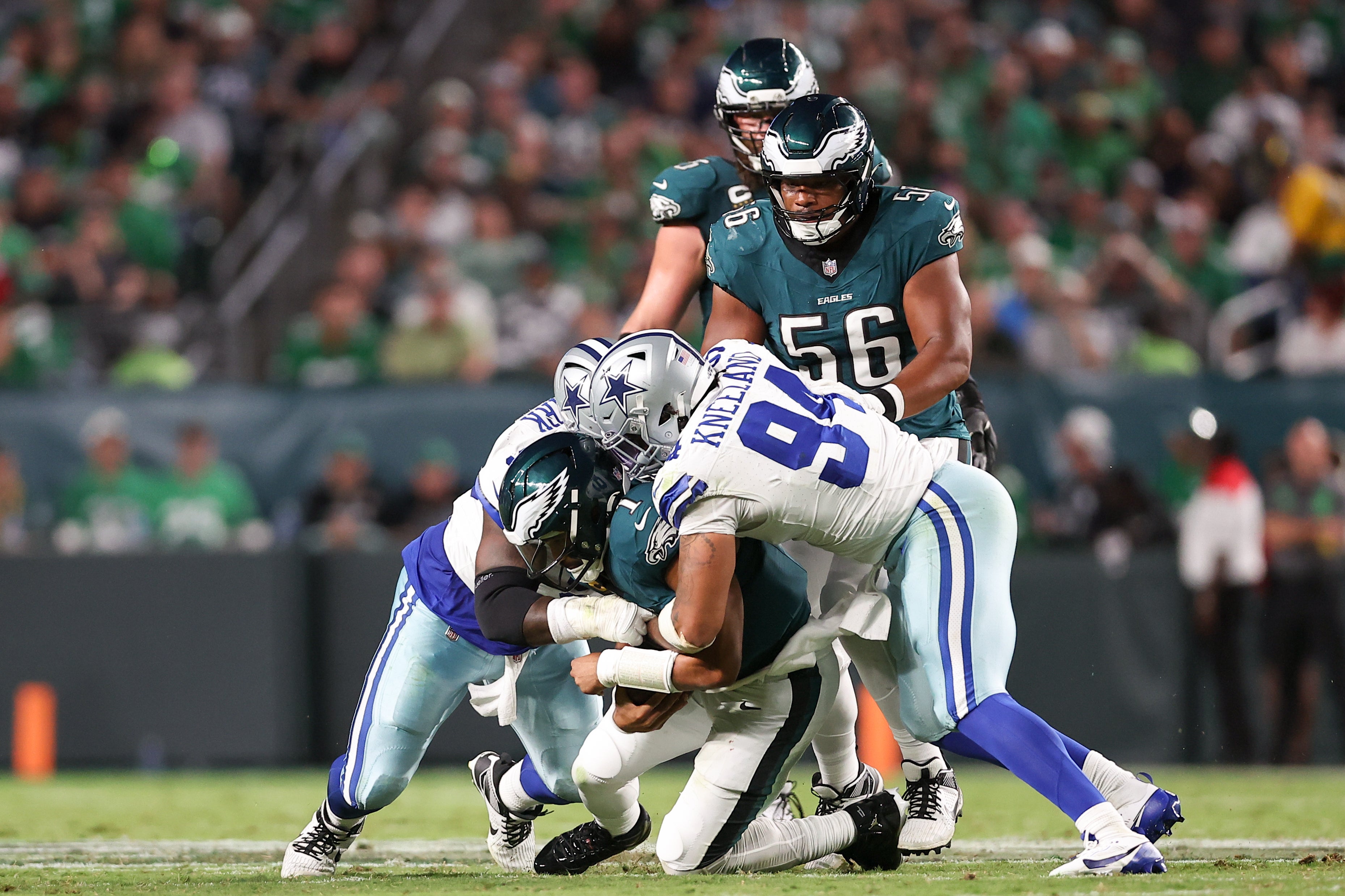Sep 4, 2025; Philadelphia, Pennsylvania, USA; Dallas Cowboys defensive end Marshawn Kneeland (94) sacks Philadelphia Eagles quarterback Jalen Hurts (1) during the third quarter of the game at Lincoln Financial Field.