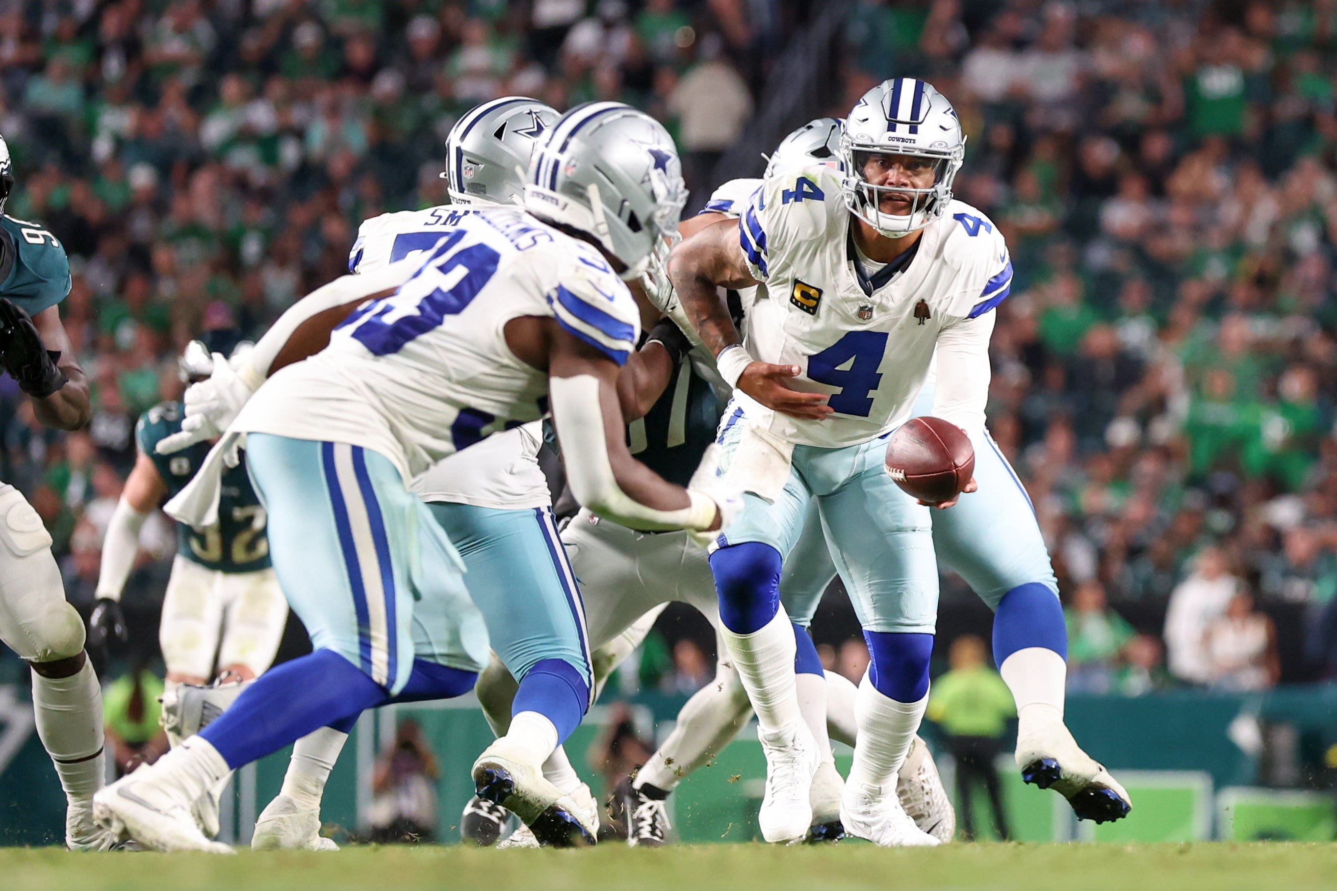 Dallas Cowboys quarterback Dak Prescott (4) hands the ball to running back Javonte Williams (33) against the Philadelphia Eagles during the fourth quarter of the game at Lincoln Financial Field.