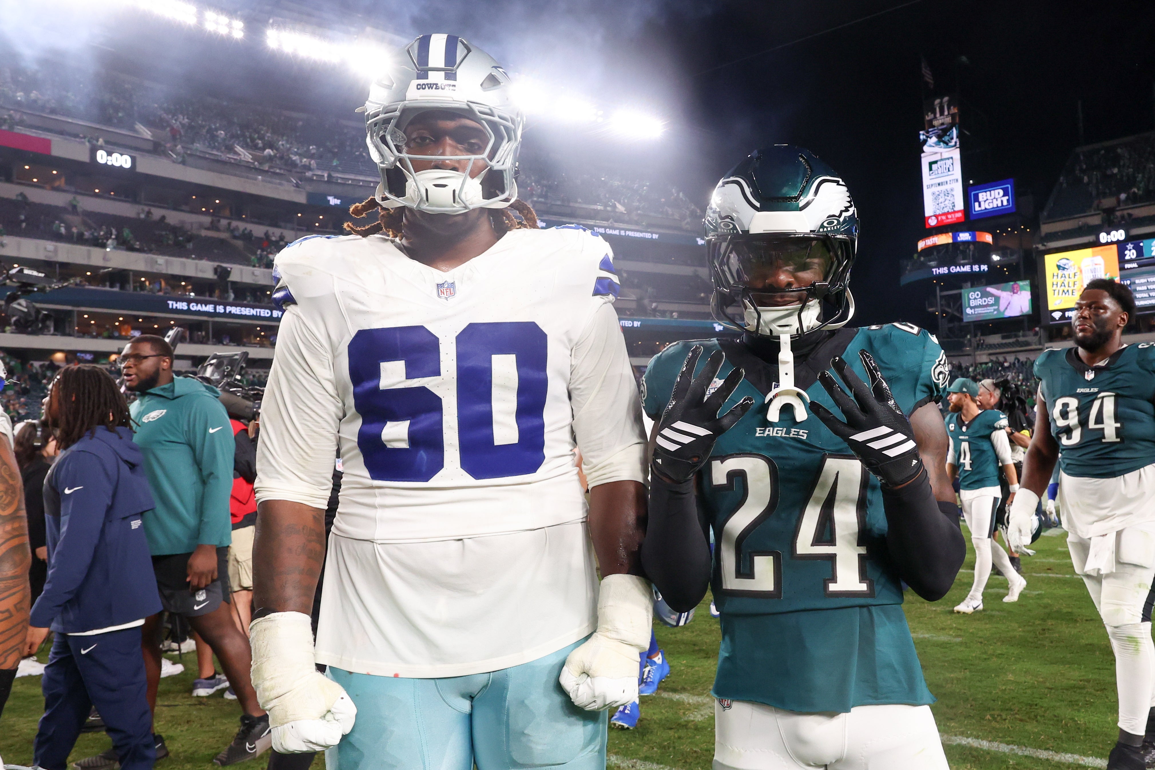 Dallas Cowboys offensive tackle Tyler Guyton (60) and Philadelphia Eagles safety Andrew Mukuba (24) pose for a photo after the game at Lincoln Financial Field.