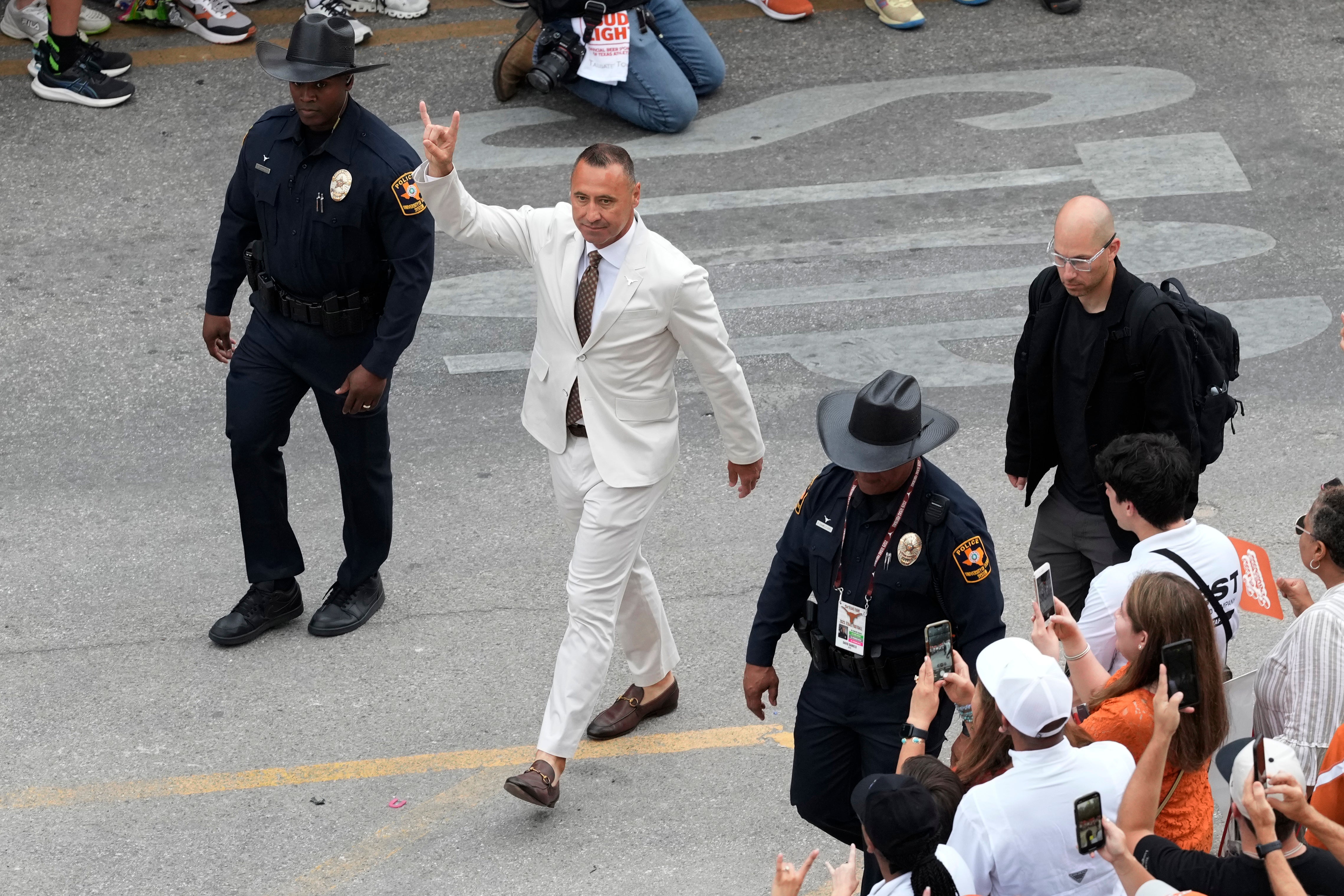 Sep 6, 2025; Austin, Texas, USA; Texas Longhorns head coach Steve Sarkisian holds his horns up while entering Darrell K Royal-Texas Memorial Stadium before a game against the San Jose Spartans.