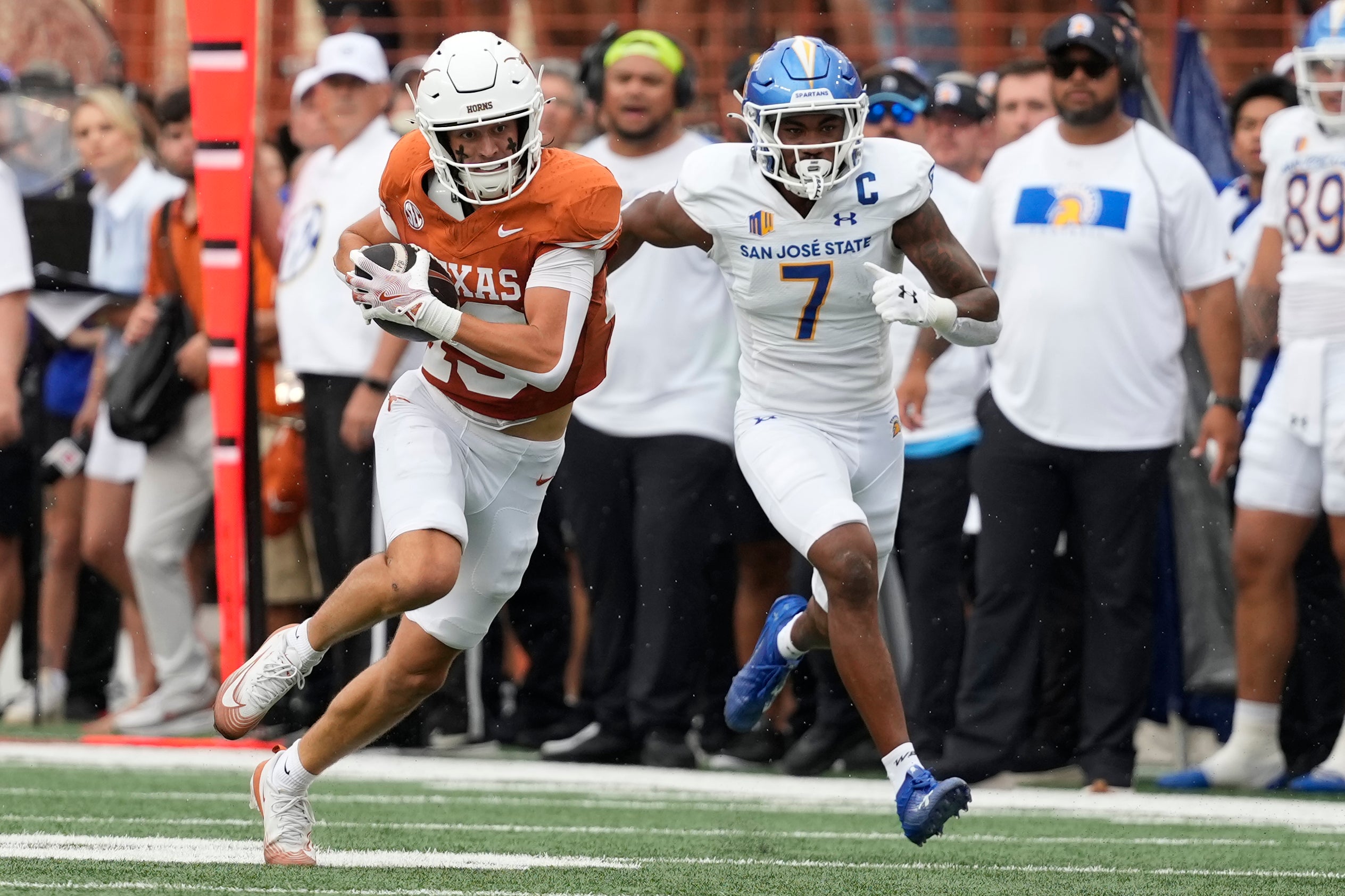 Sep 6, 2025; Austin, Texas, USA; Texas Longhorns wide receiver Parker Livingstone (13) runs for yards while defended by San Jose State Spartans defensive back Jalen Apalit-Williams (7) during the first half at Darrell K Royal-Texas Memorial Stadium.