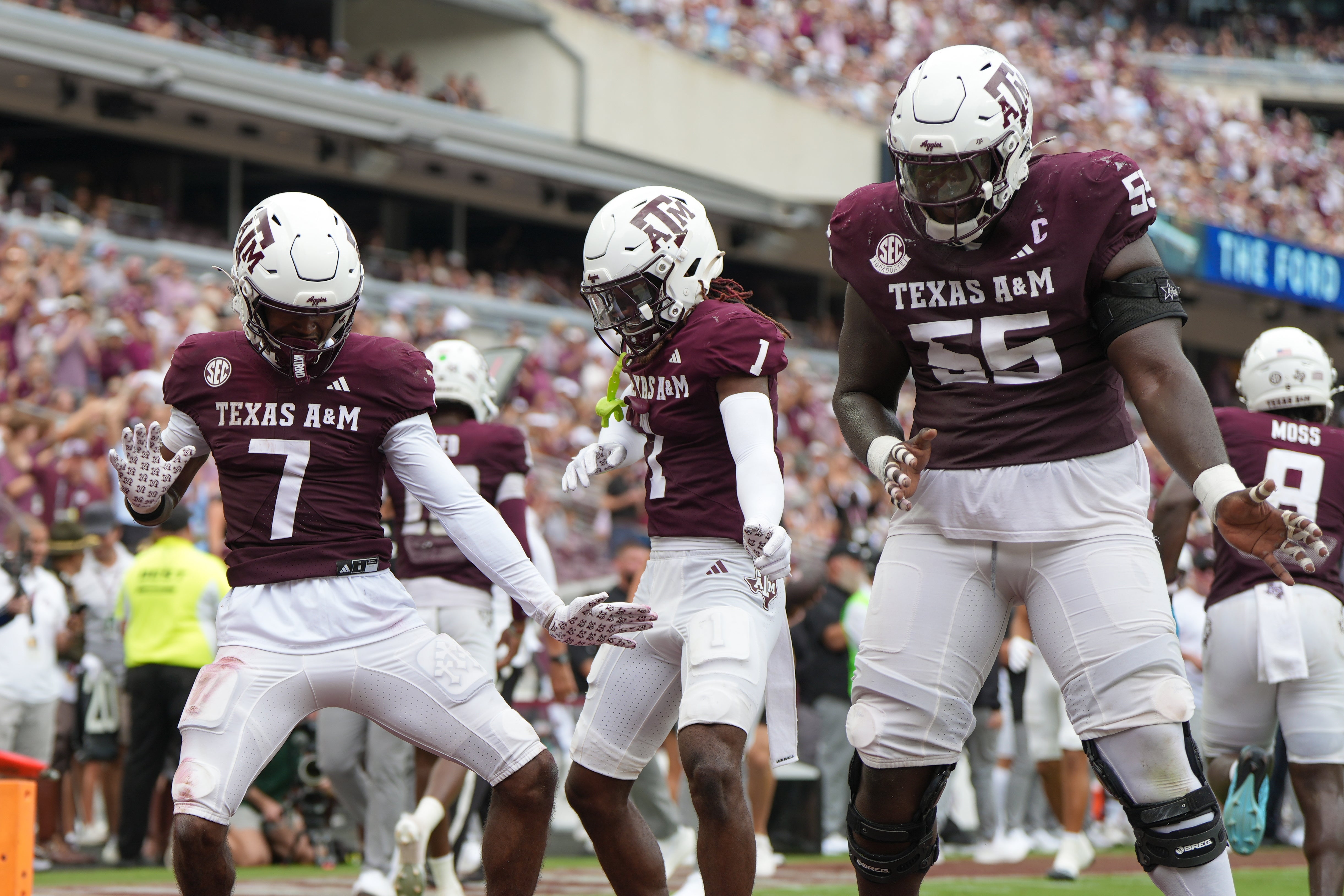 Sep 6, 2025; College Station, Texas, USA; Texas A&M Aggies wide receiver KC Concepcion (7), Texas A&M Aggies wide receiver Mario Craver (1), and Texas A&M Aggies offensive lineman Ar'maj Reed-Adams (55) celebrate after a touchdown during the second quarter against the Utah State Aggies at Kyle Field. Mandatory Credit: Sean Thomas-Imagn Images