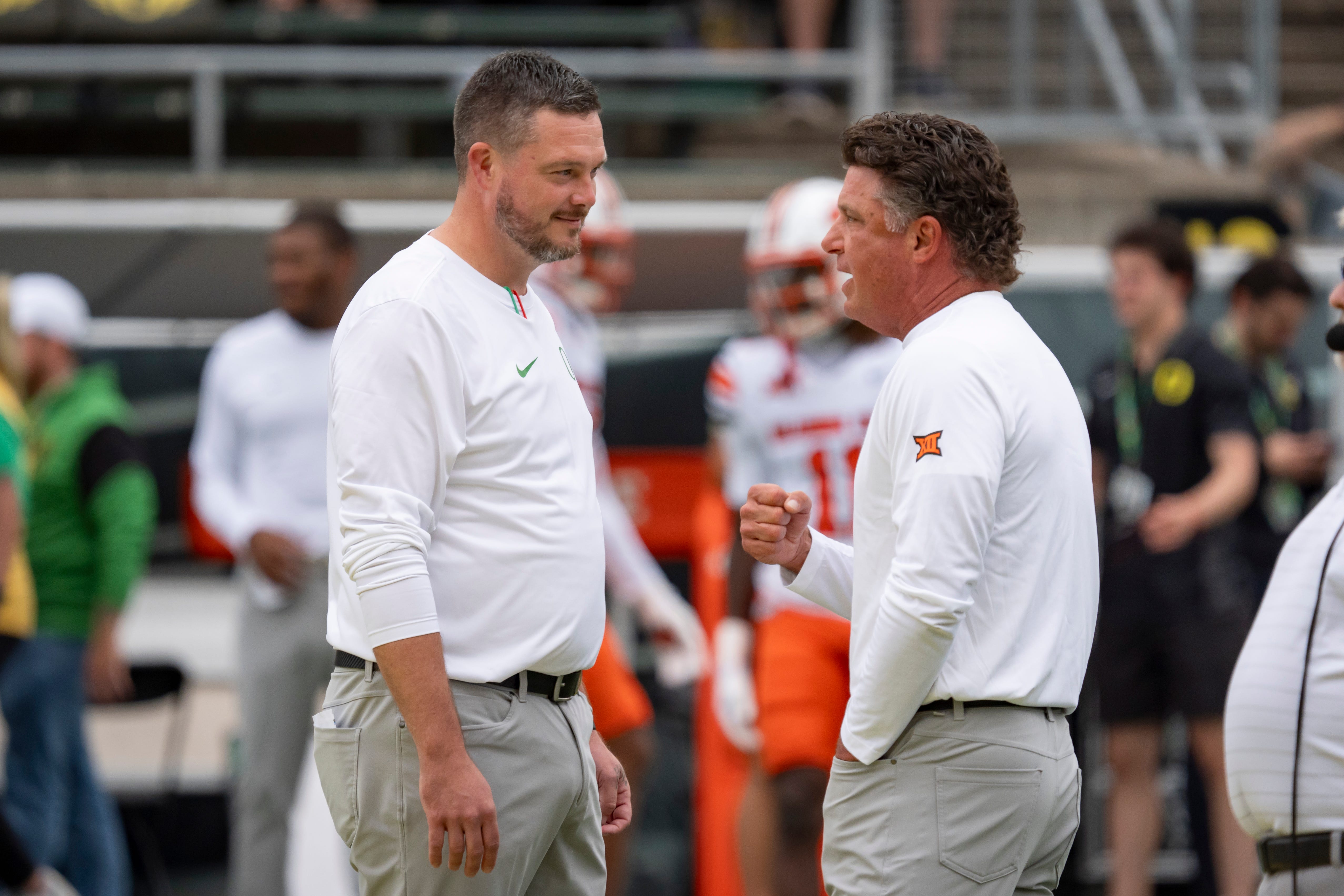 Oregon head coach Dan Lanning, left, and Oklahoma State head coach Mike Gundy talk before the game as the Oregon Ducks host the Oklahoma State Cowboys on Sept. 6, 2025, at Autzen Stadium in Eugene, Oregon.