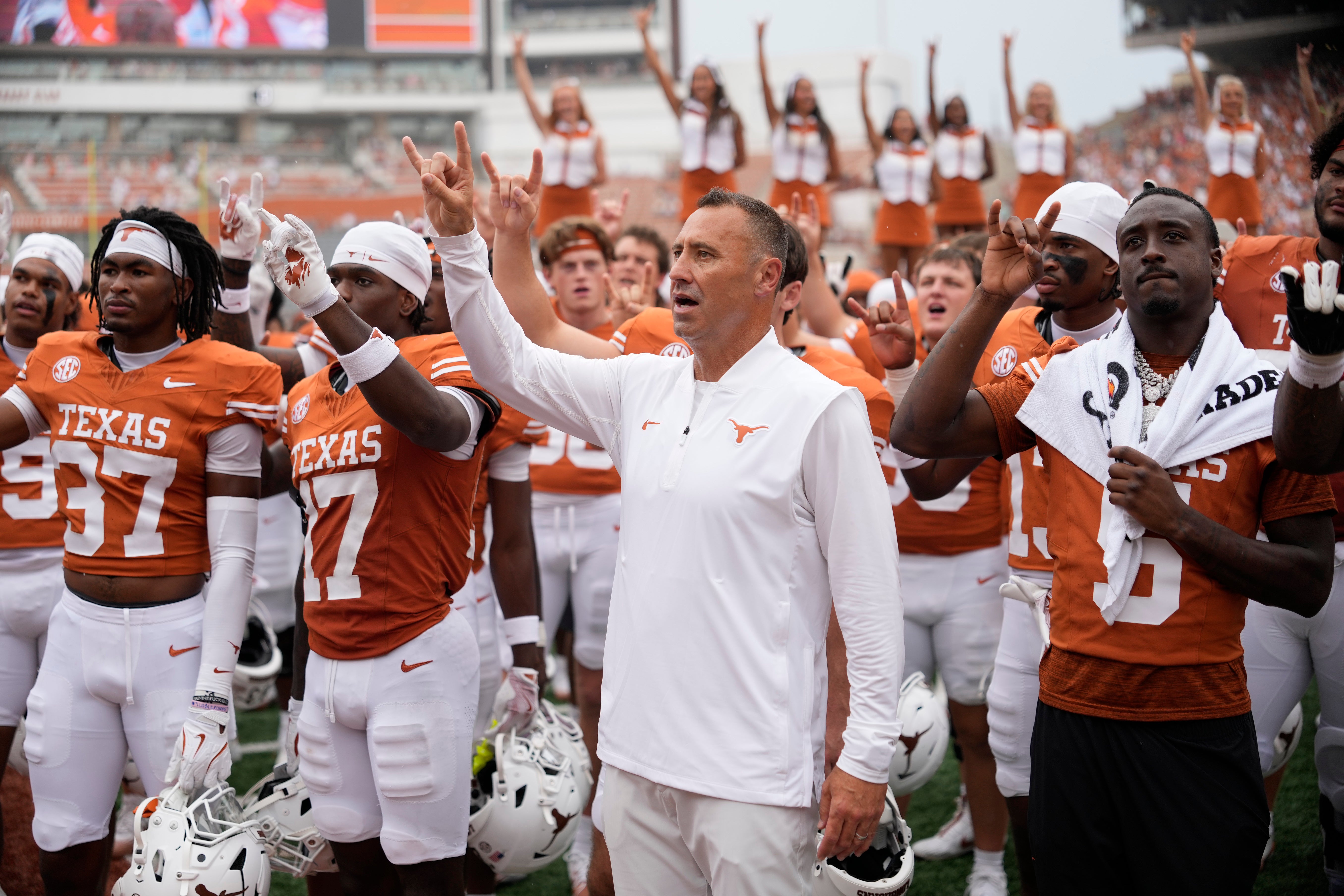 Sep 6, 2025; Austin, Texas, USA; Texas Longhorns head coach Steve Sarkisian and players hold up their horns with the fans during the singing of the Eyes of Texas after a victory over the San Jose State Spartans at Darrell K Royal-Texas Memorial Stadium.