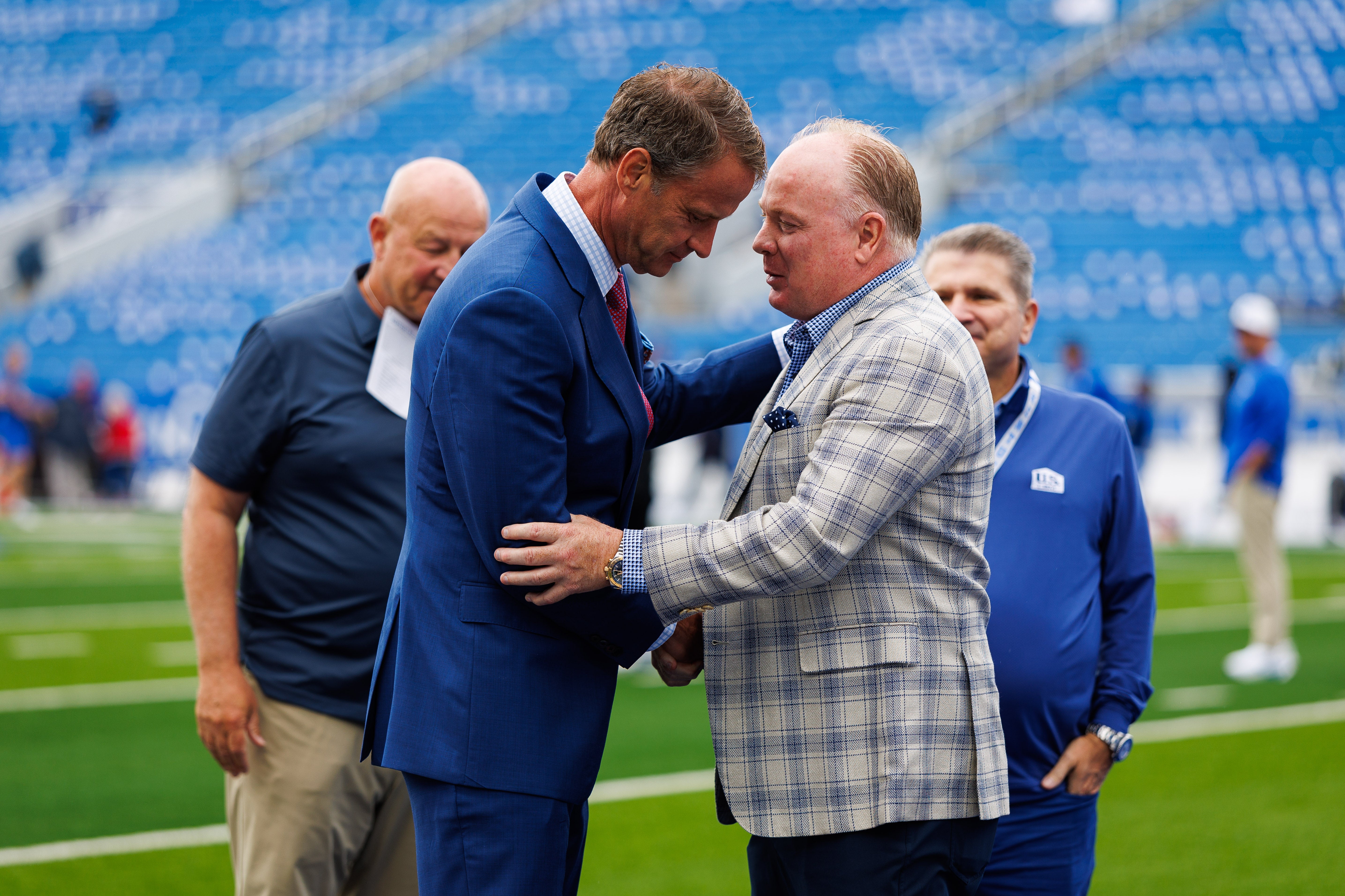 Sep 6, 2025; Lexington, Kentucky, USA; Kentucky Wildcats head coach Mark Stoops, right, greets Mississippi Rebels head coach Lane Kiffin before the game at Kroger Field.