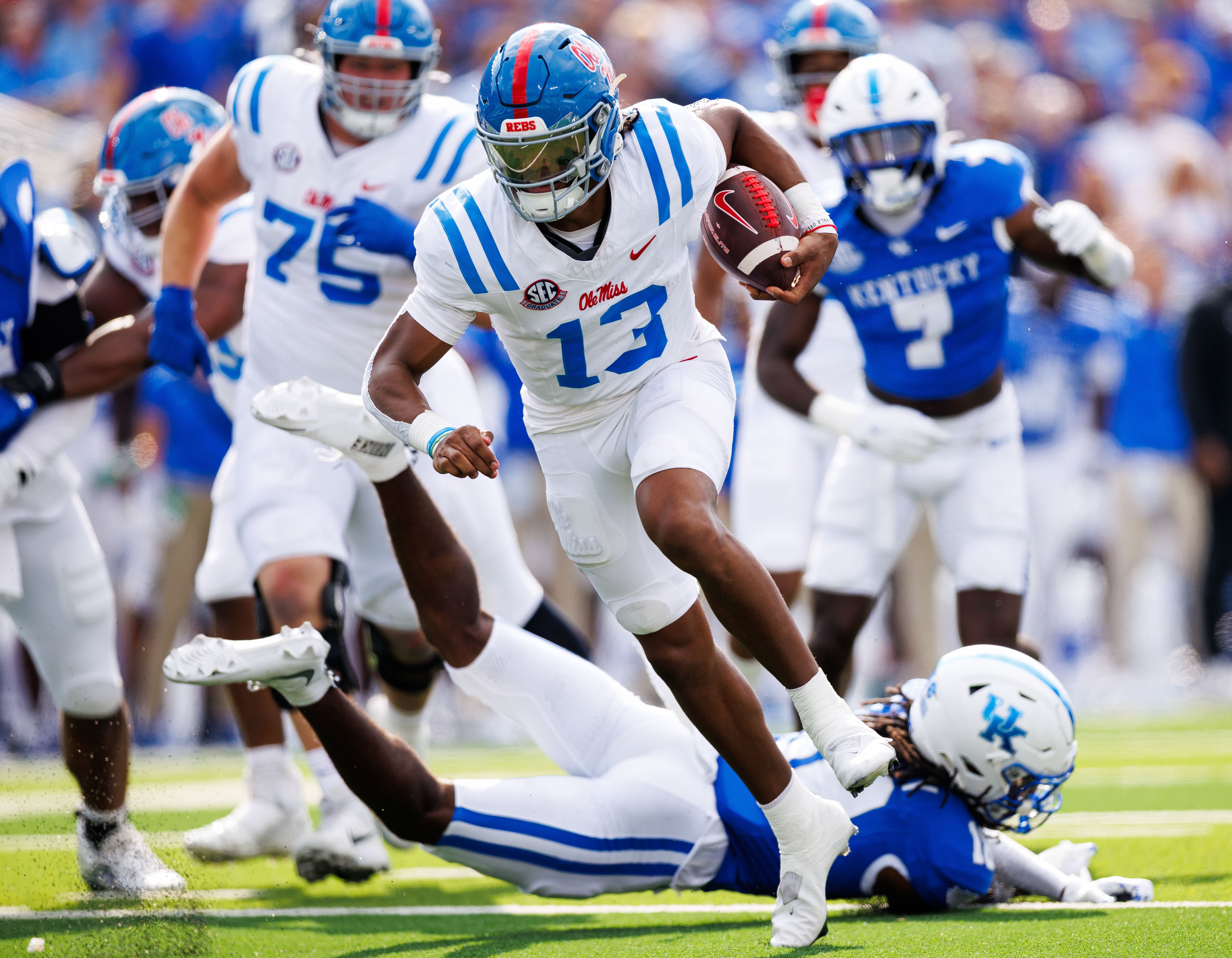Sep 6, 2025; Lexington, Kentucky, USA; Mississippi Rebels quarterback Austin Simmons (13) runs the ball during the second quarter against the Kentucky Wildcats at Kroger Field.
