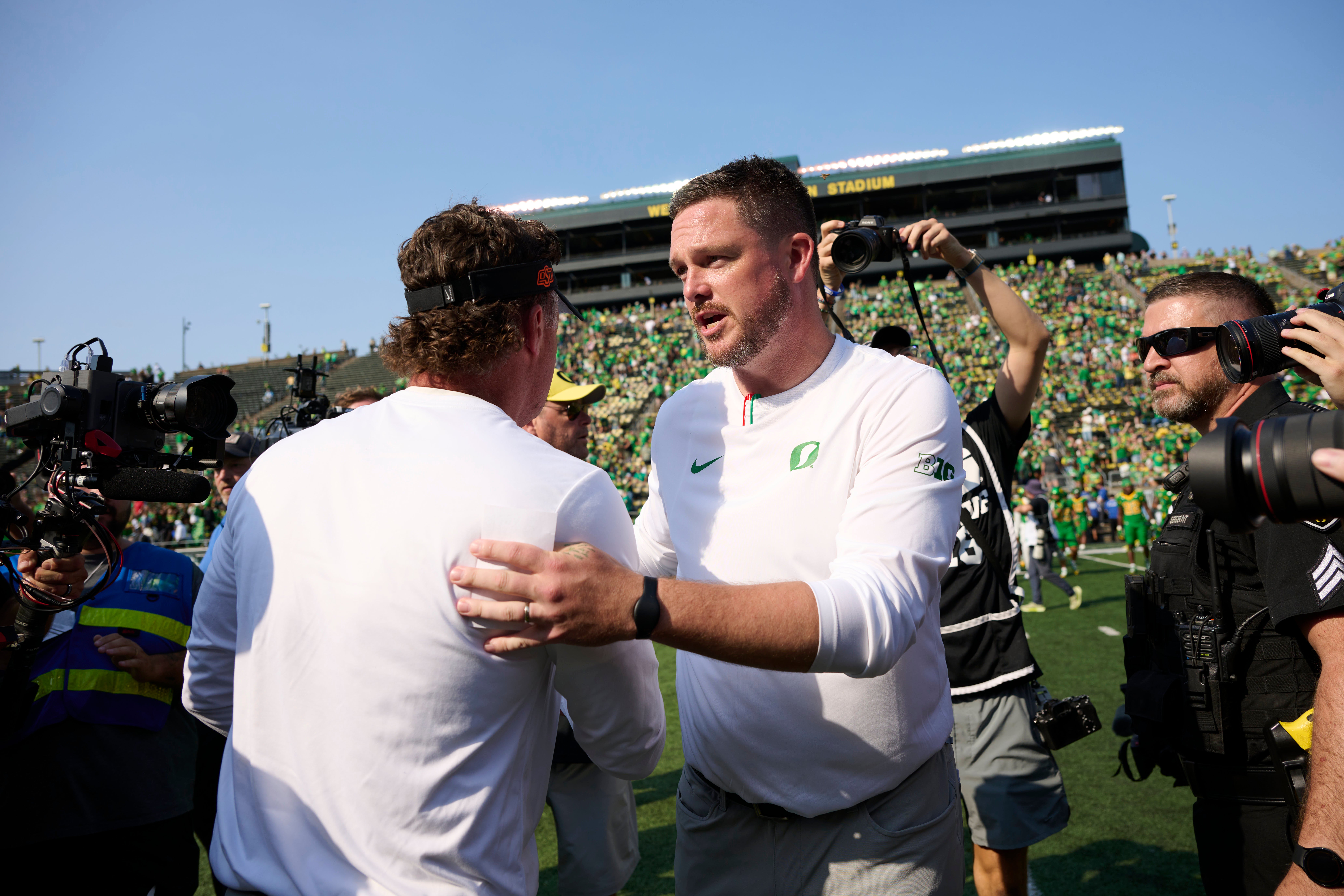 Sep 6, 2025; Eugene, Oregon, USA; Oregon Ducks head coach Dan Lanning shakes the hand of Oklahoma State Cowboys head coach Mike Gundy after a game at Autzen Stadium. Mandatory Credit: Troy Wayrynen-Imagn Images