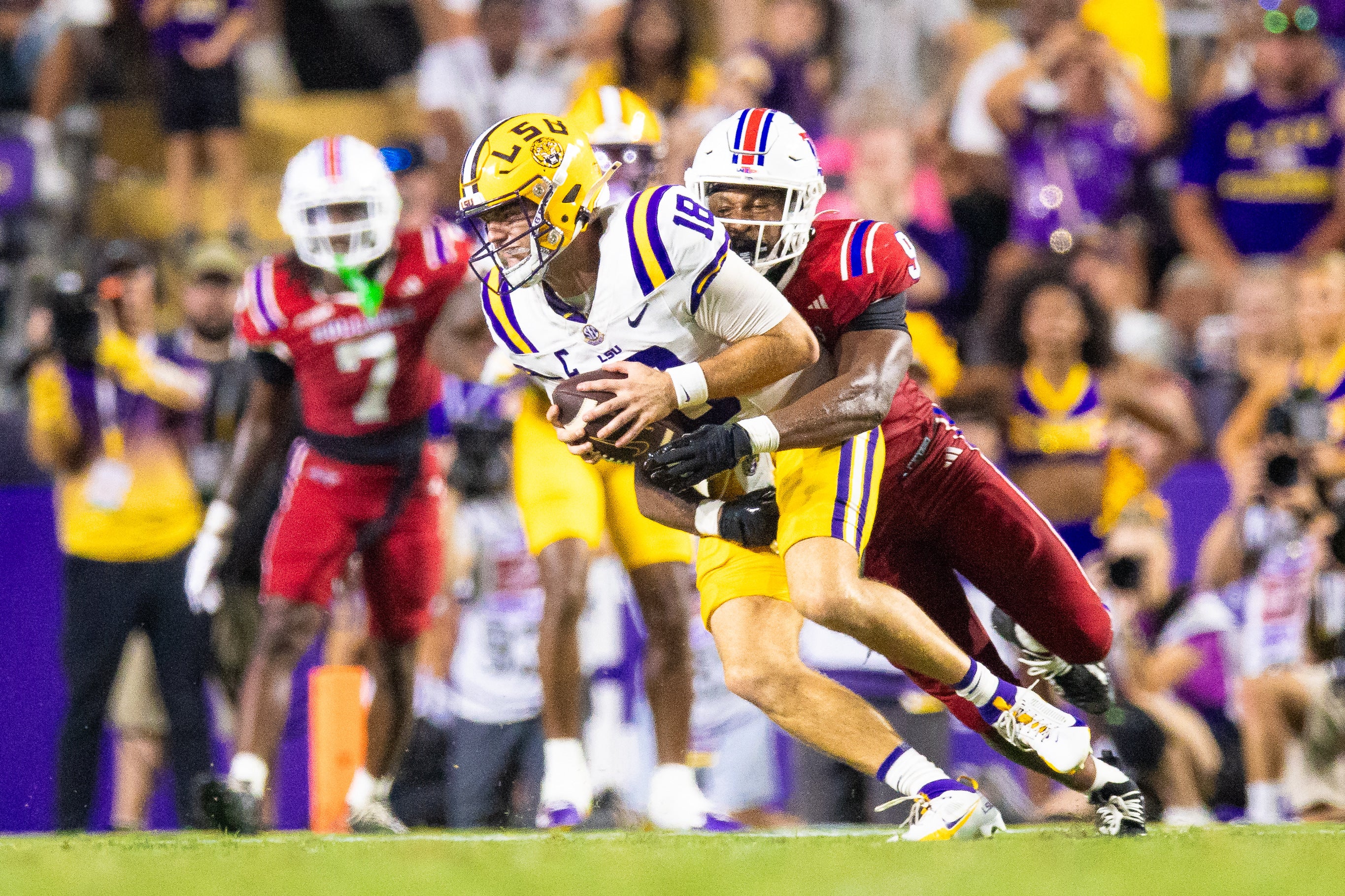 Sep 6, 2025; Baton Rouge, Louisiana, USA; LSU Tigers quarterback Garrett Nussmeier (18) is sacked by Louisiana Tech Bulldogs linebacker Mekhi Mason (9) during the second half at Tiger Stadium. Mandatory Credit: Stephen Lew-Imagn Images