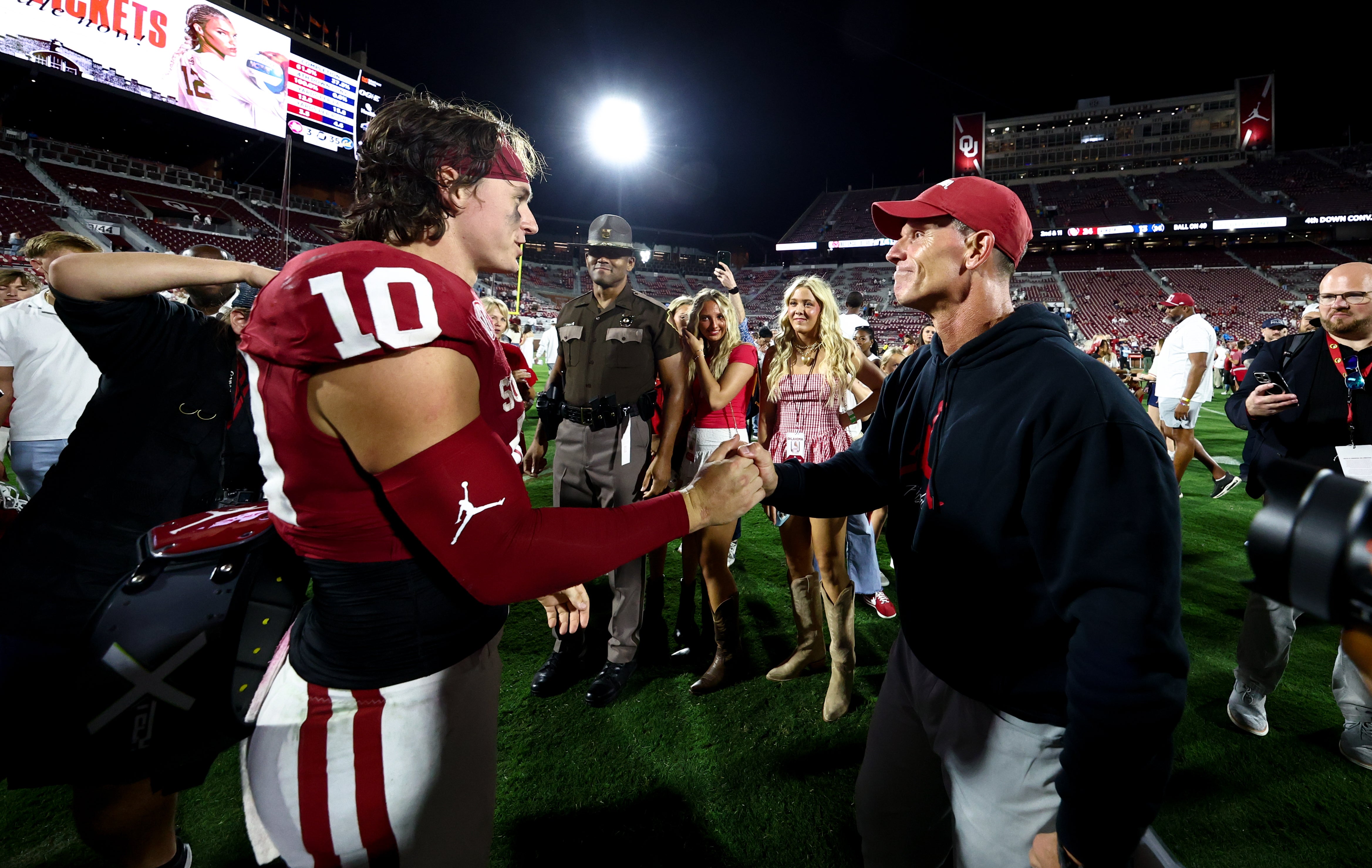 Sep 6, 2025; Norman, Oklahoma, USA; Oklahoma Sooners quarterback John Mateer (10) celebrates with head coach Brent Venables after the game against the Michigan Wolverines at Gaylord Family-Oklahoma Memorial Stadium.