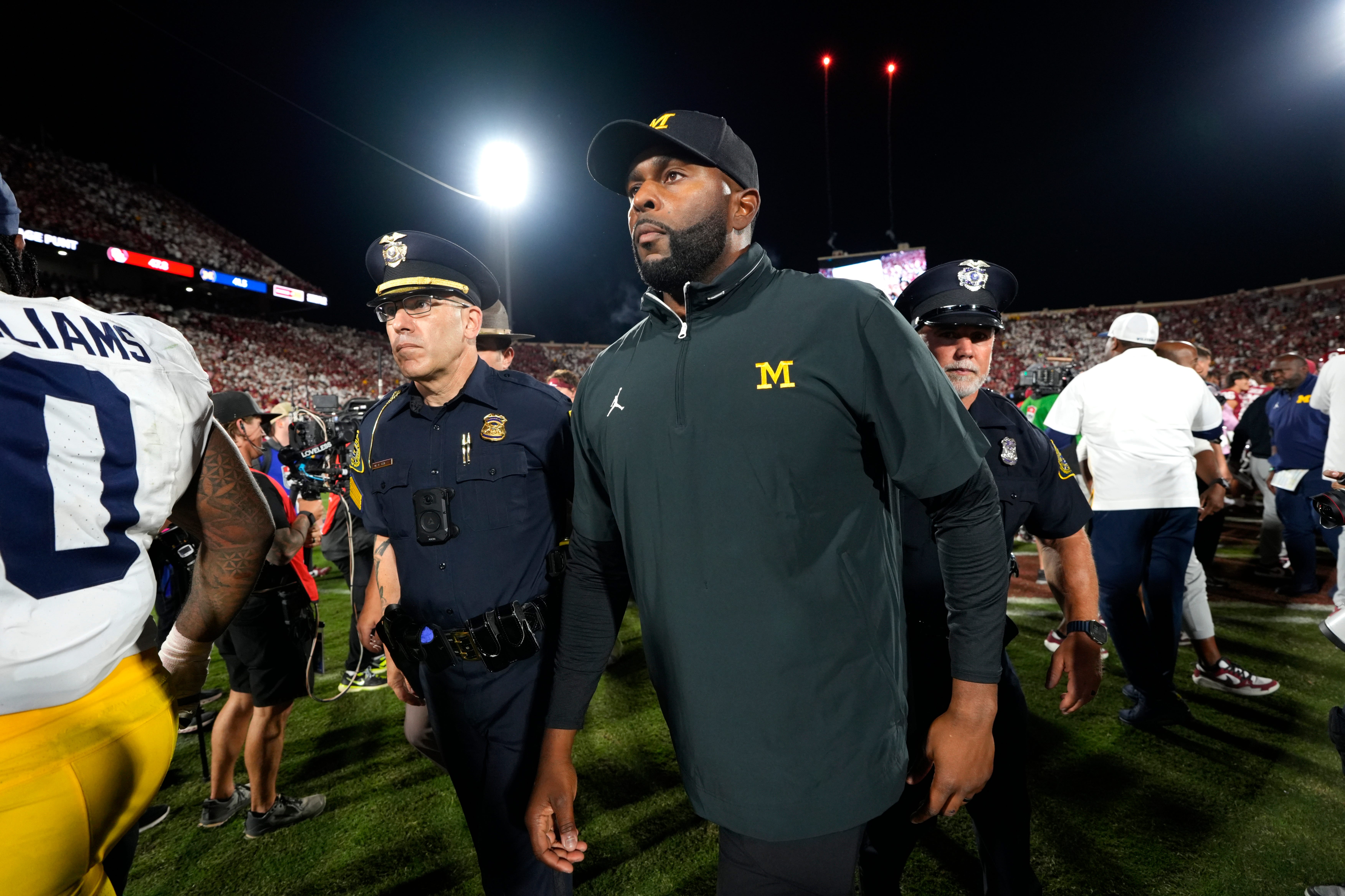 Michigan coach Sherrone Moore leaves the field after a college football game between the University of Oklahoma Sooners (OU) and the University of Michigan Wolverines at Gaylord Family Ð Oklahoma Memorial Stadium in Norman, Okla., Saturday, Sept. 6, 2025. Oklahoma won 24-13.