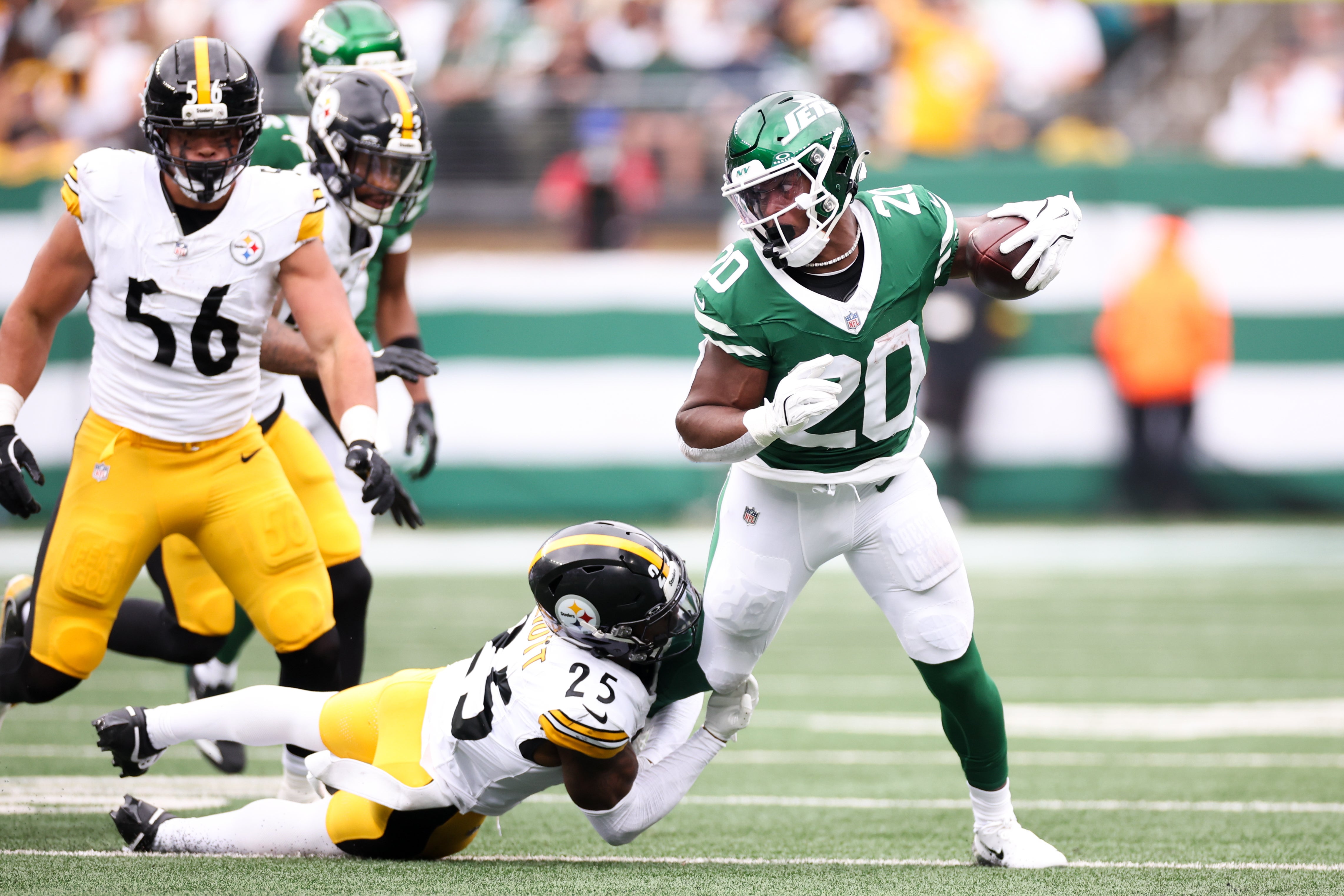 Sep 7, 2025; East Rutherford, New Jersey, USA; New York Jets running back Breece Hall (20) is tackled by Pittsburgh Steelers safety DeShon Elliott (25) during the first quarter at MetLife Stadium.