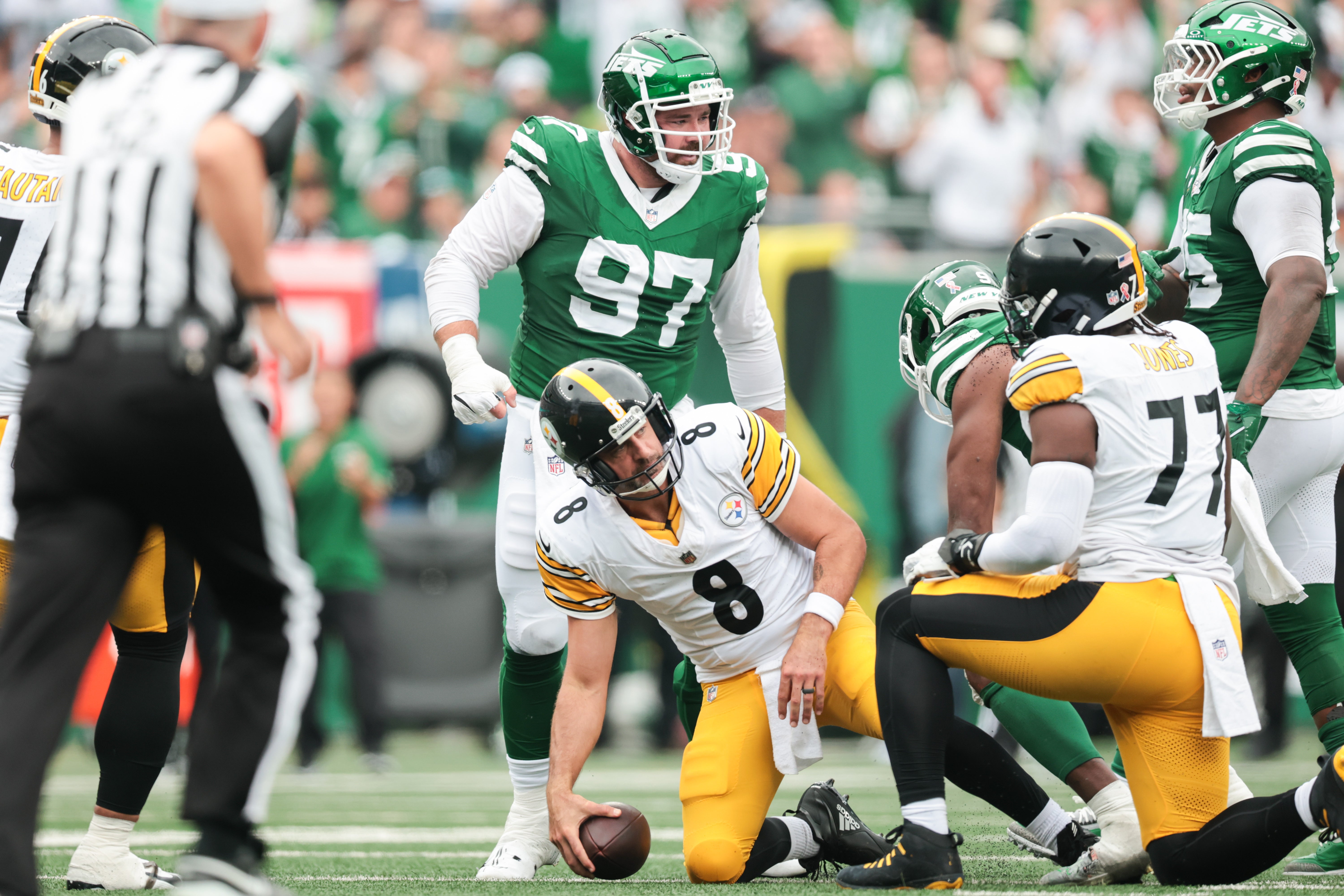 Sep 7, 2025; East Rutherford, New Jersey, USA; Pittsburgh Steelers quarterback Aaron Rodgers (8) reacts after being sacked by New York Jets defensive end Will McDonald IV (9) at MetLife Stadium.