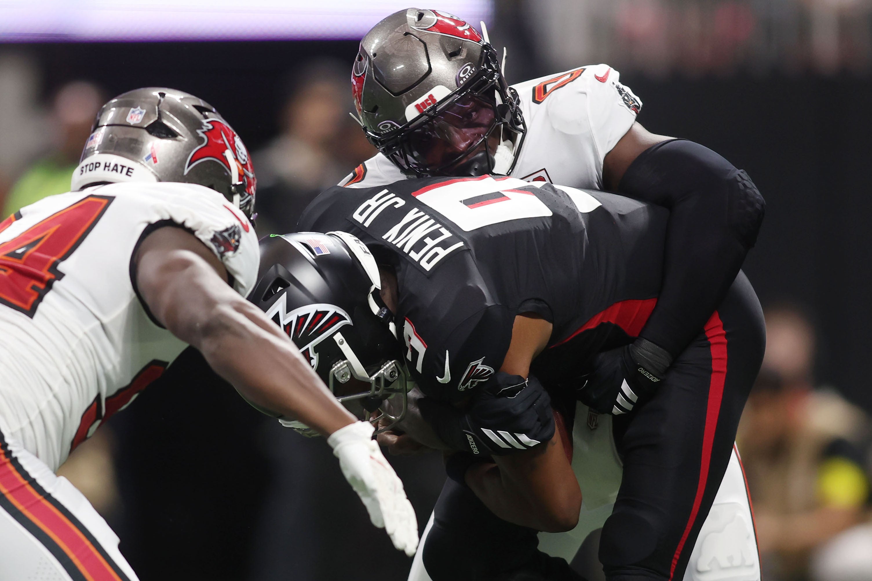 Sep 7, 2025; Atlanta, Georgia, USA; Tampa Bay Buccaneers linebacker Yaya Diaby (0) and defensive tackle Calijah Kancey (94) tackle Atlanta Falcons quarterback Michael Penix Jr. (9) during the second quarter at Mercedes-Benz Stadium.
