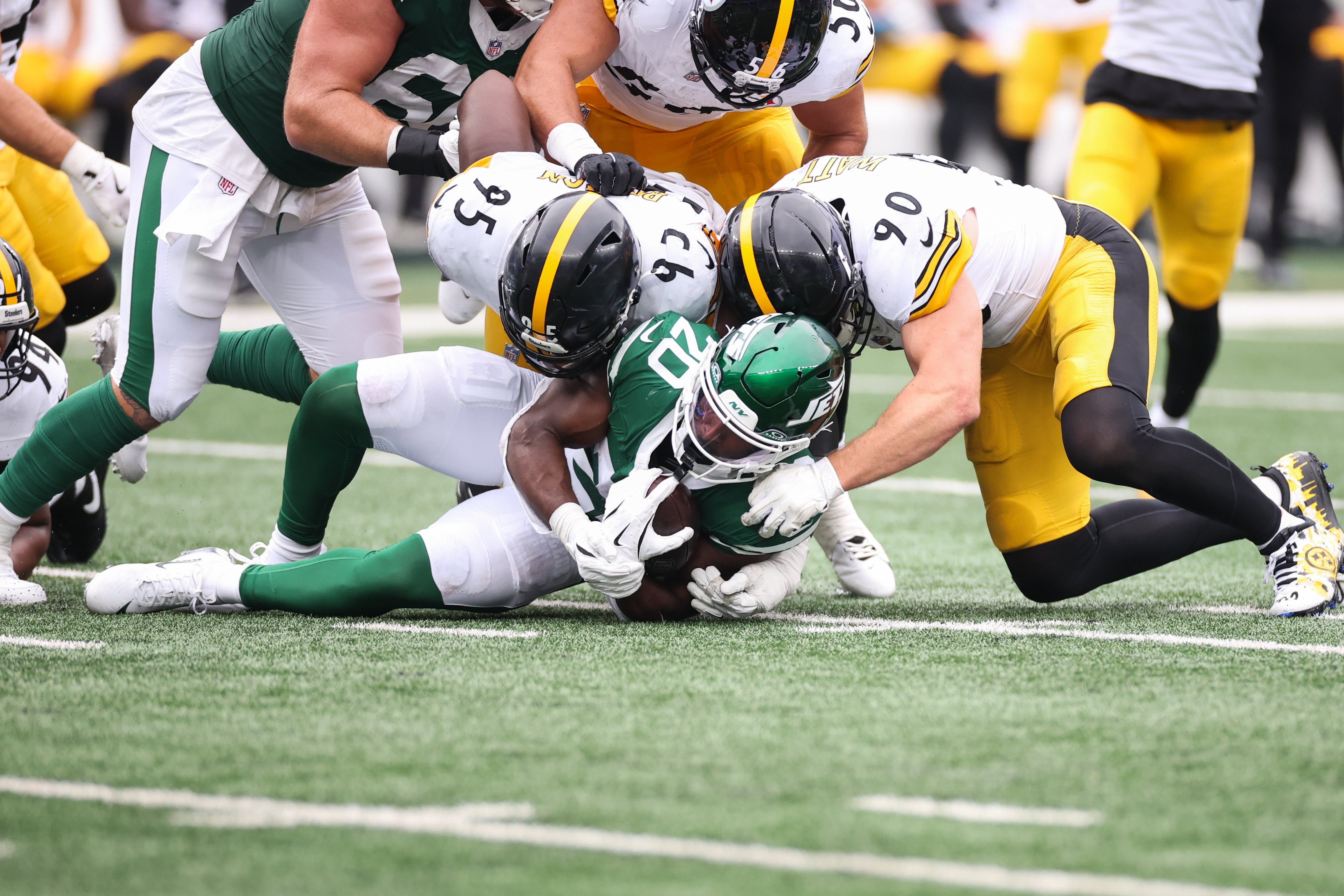 Sep 7, 2025; East Rutherford, New Jersey, USA; New York Jets running back Breece Hall (20) is tackled by Pittsburgh Steelers linebacker T.J. Watt (90) and defensive tackle Keeanu Benton (95) during the second quarterat MetLife Stadium.