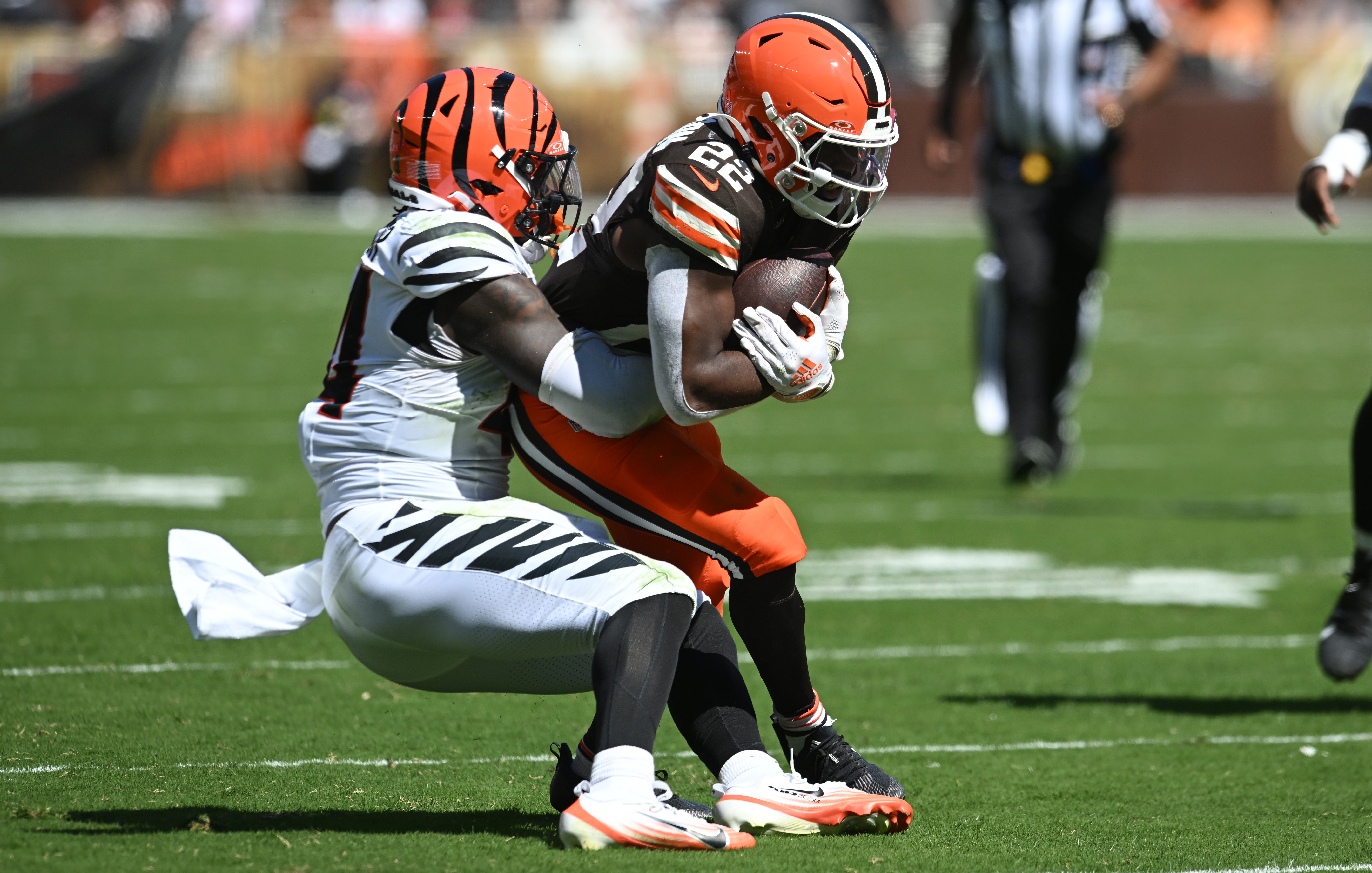 Sep 7, 2025; Cleveland, Ohio, USA; Cleveland Browns running back Dylan Sampson (22) is tackled by Cincinnati Bengals linebacker Demetrius Knight Jr. (44) during the second half at Huntington Bank Field.