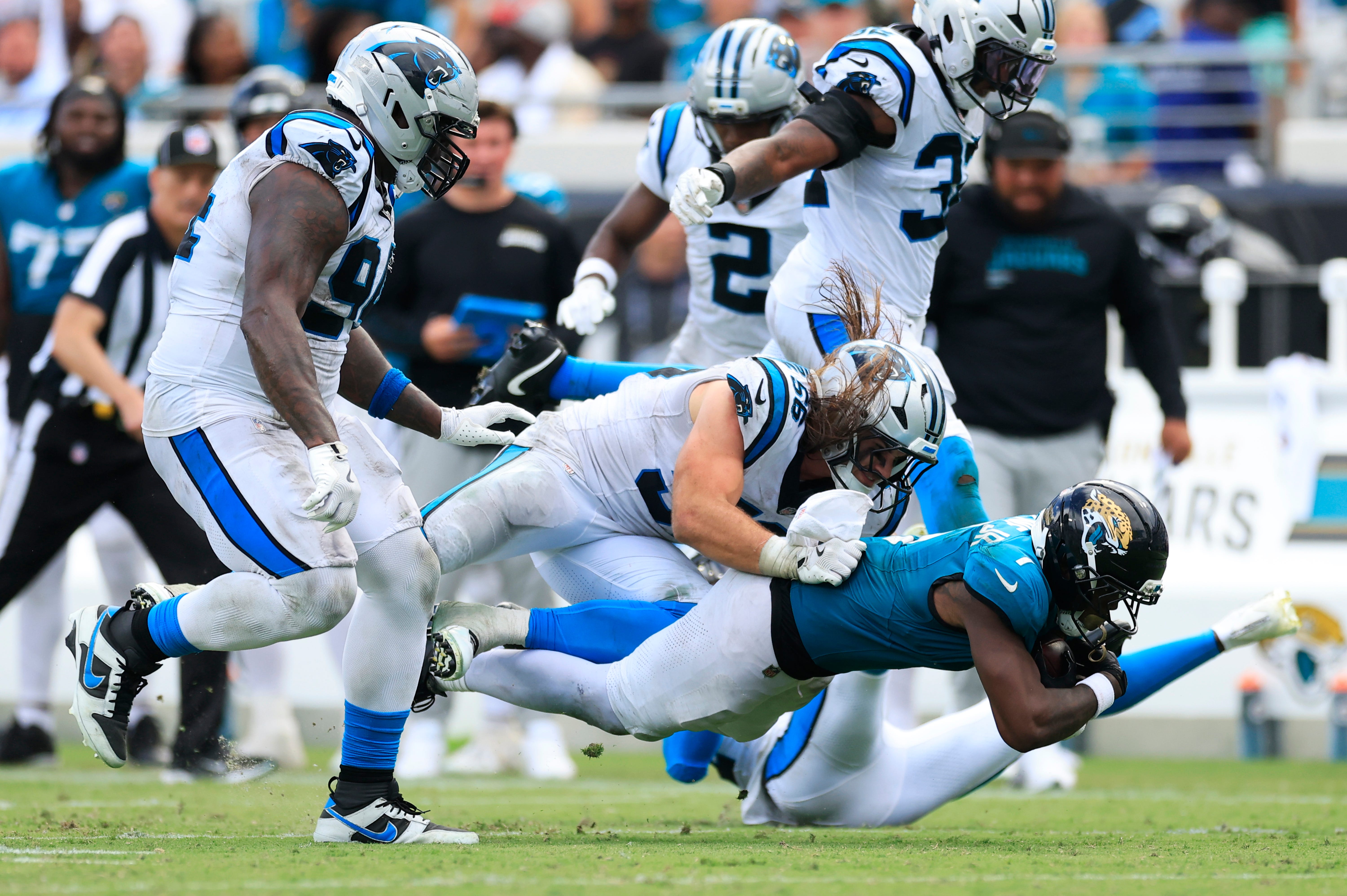 Jacksonville Jaguars running back Travis Etienne Jr. (1) rushes for yards against Carolina Panthers linebacker Christian Rozeboom (56) during the fourth quarter of an NFL football matchup at EverBank Stadium, Sunday, Sept. 7, 2025 in Jacksonville, Fla. The Jaguars defeated the Panthers 26-10.