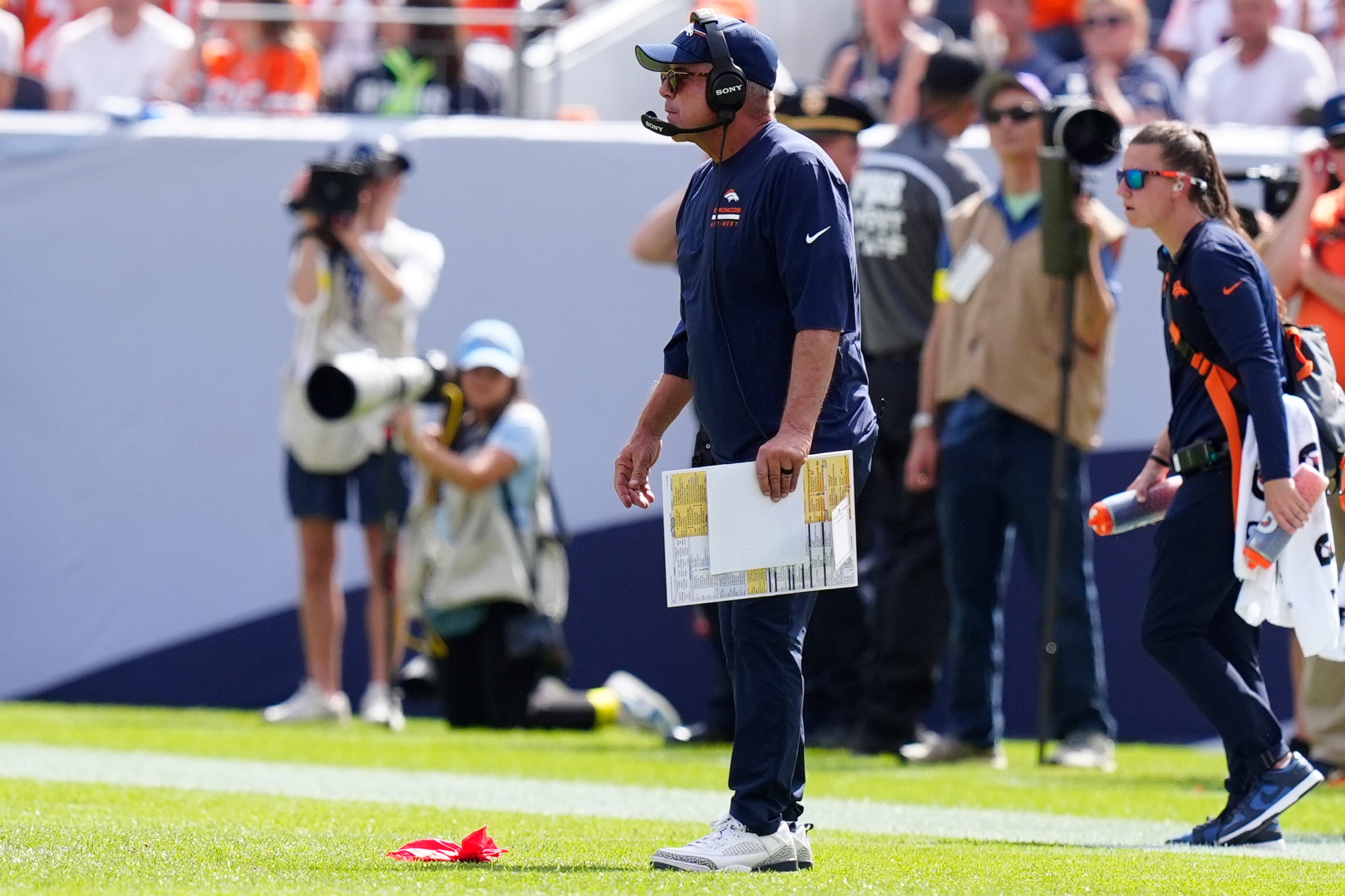 Sep 7, 2025; Denver, Colorado, USA; Denver Broncos head coach Sean Payton throws the red flag after a play against the Tennessee Titans in the first half at Empower Field at Mile High.