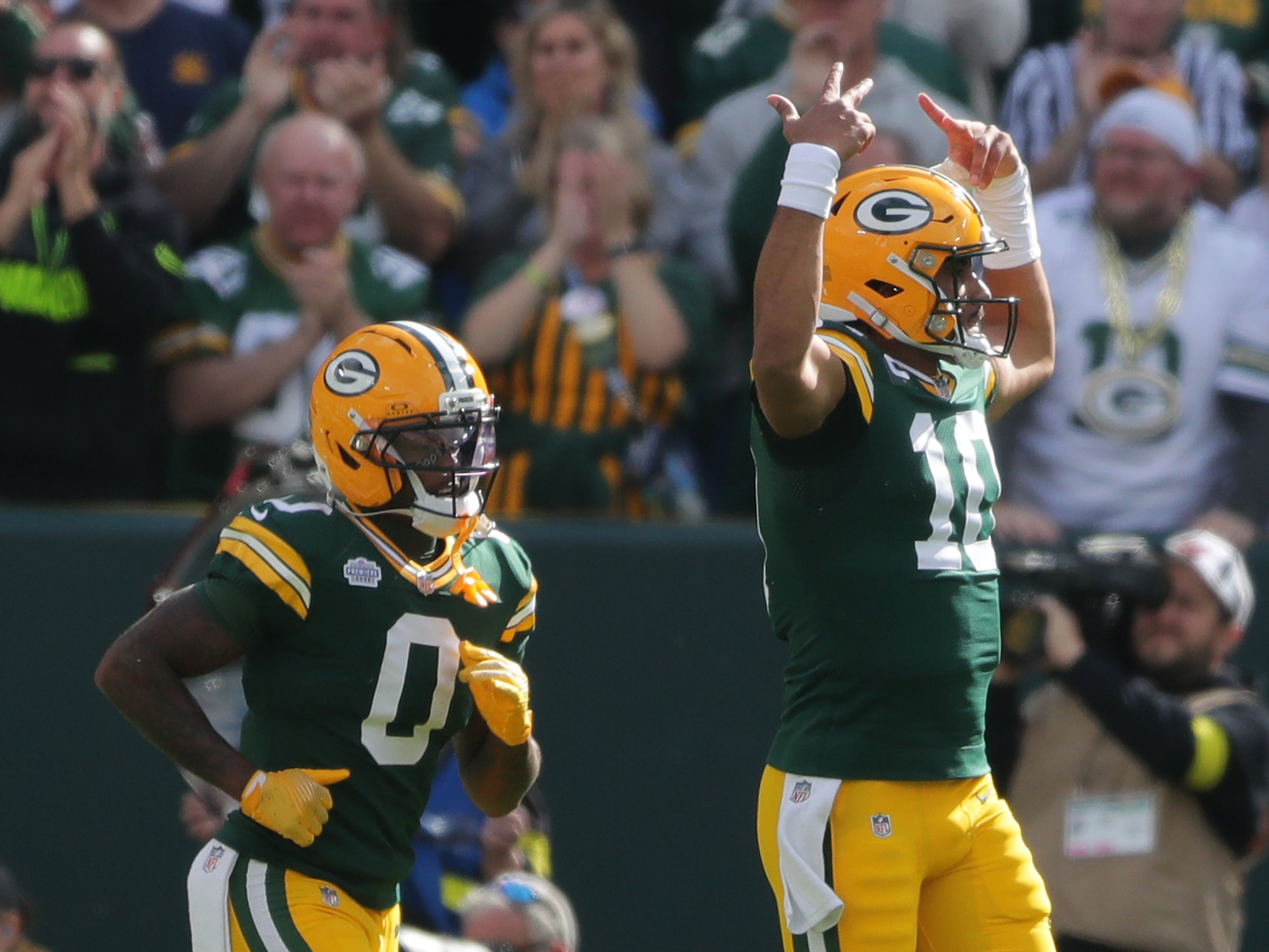 Green Bay Packers quarterback Jordan Love (10) and wide receiver Matthew Golden (0) react after a play during the first half at Lambeau Field.