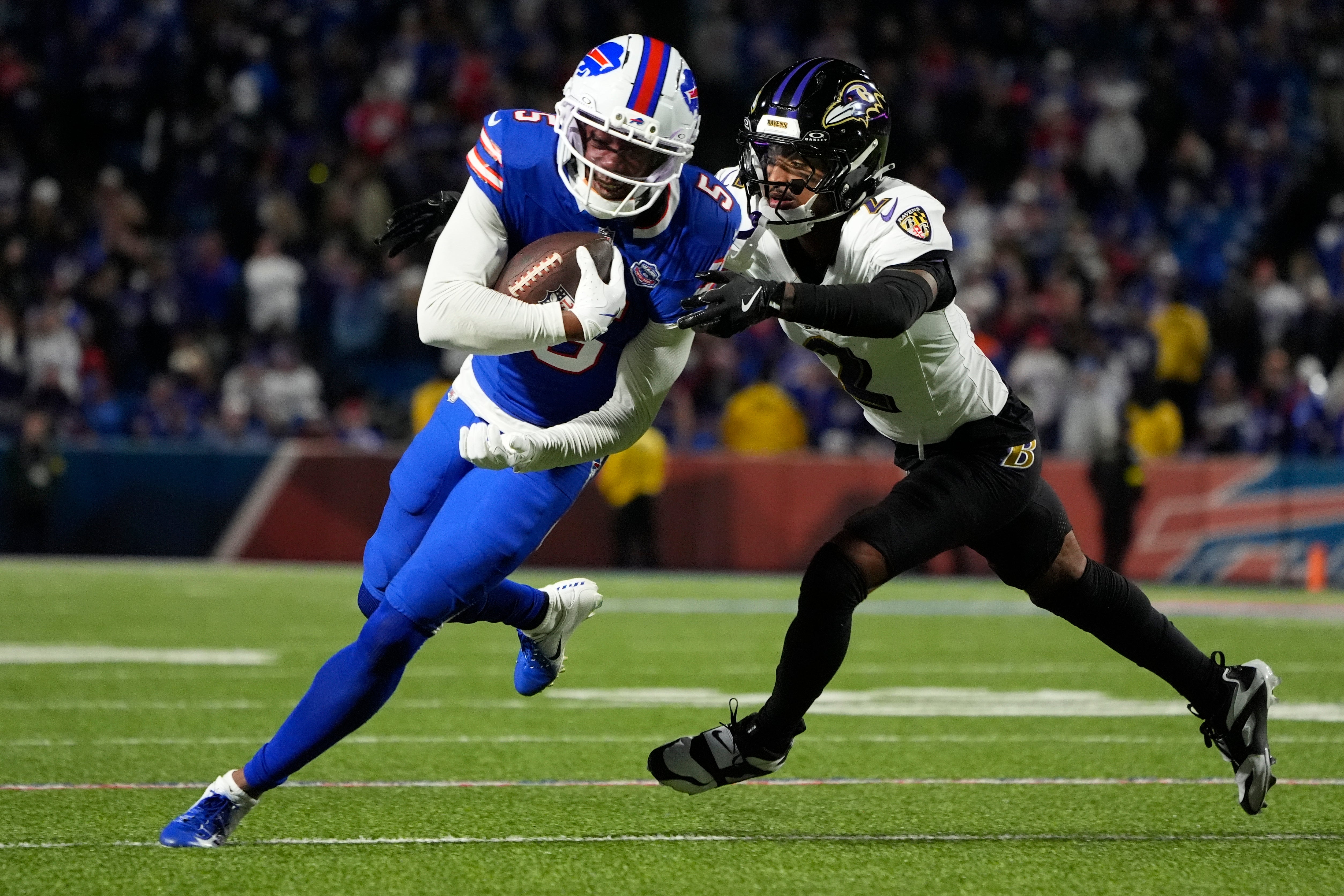 Sep 7, 2025; Orchard Park, New York, USA; Buffalo Bills wide receiver Joshua Palmer (5) runs the ball against Baltimore Ravens cornerback Nate Wiggins (2) during the fourth quarter at Highmark Stadium.