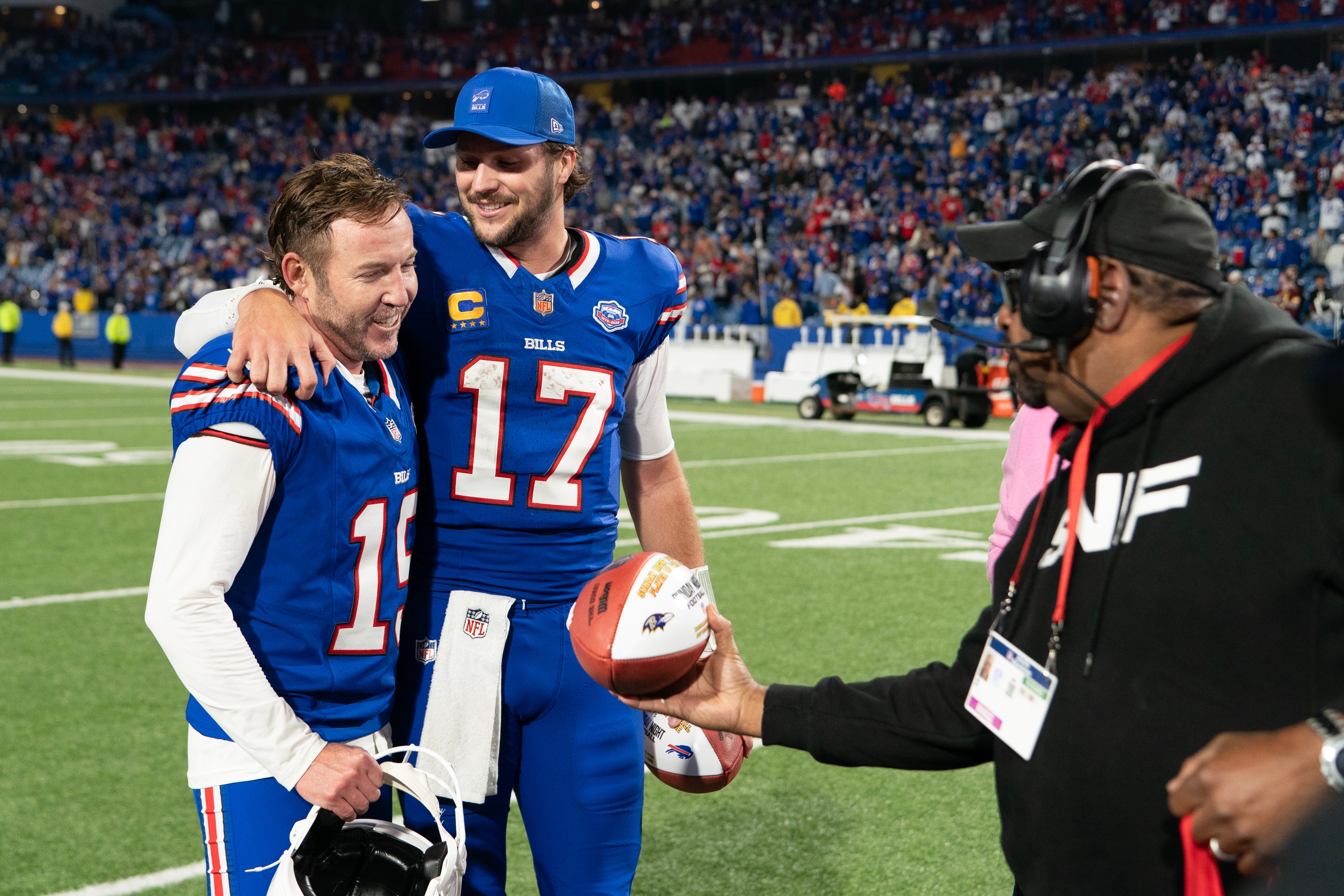 Sep 7, 2025; Orchard Park, New York, USA; Buffalo Bills place kicker Matt Prater (19) is presented with the Sunday Night Football game ball along with Buffalo Bills quarterback Josh Allen (17) after the game between the Baltimore Ravens and Buffalo Bills at Highmark Stadium.