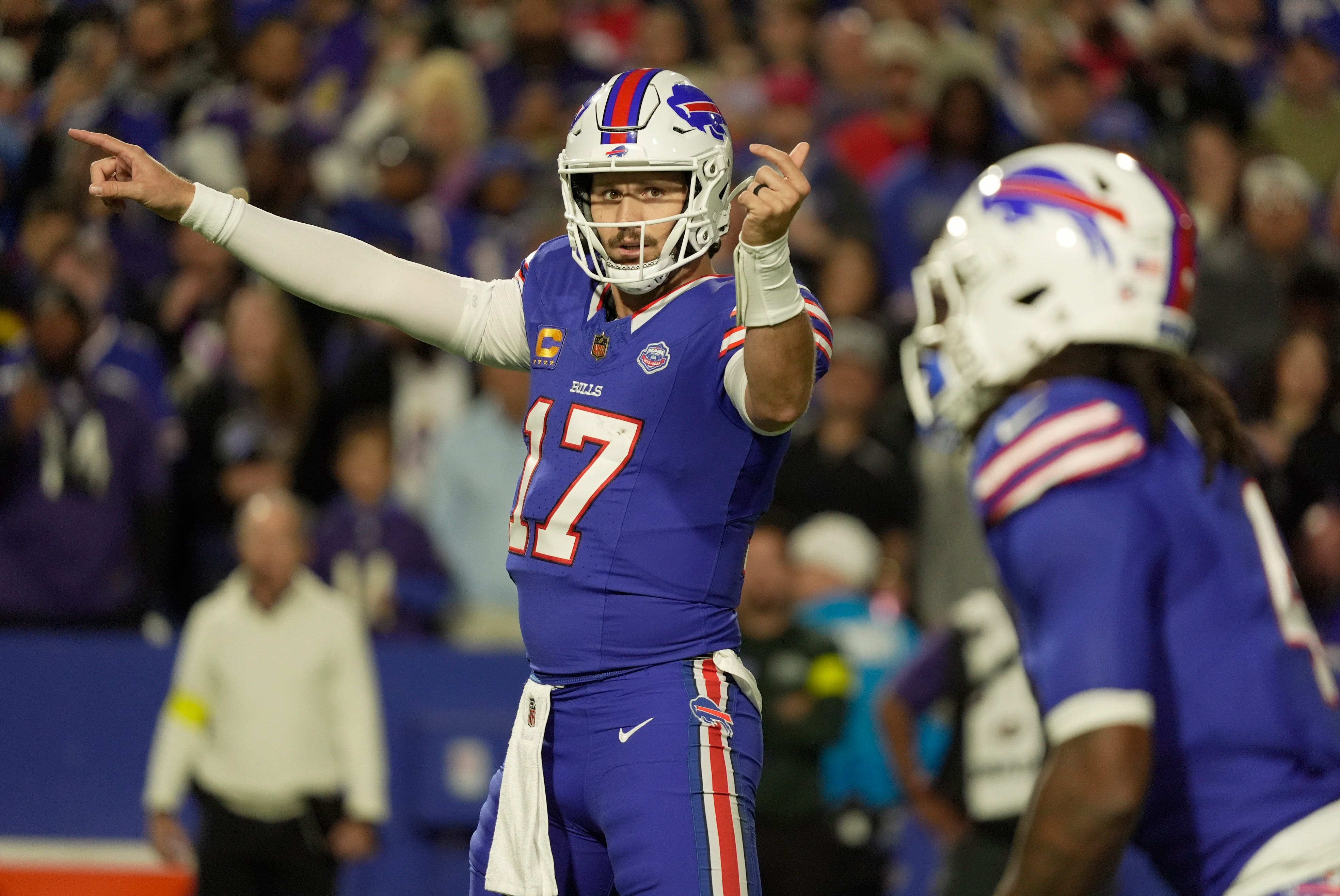 Buffalo Bills quarterback Josh Allen signals to running back James Cook during first half action against the Baltimore Ravens at Highmark Stadium in Orchard Park on Sept. 7, 2025.