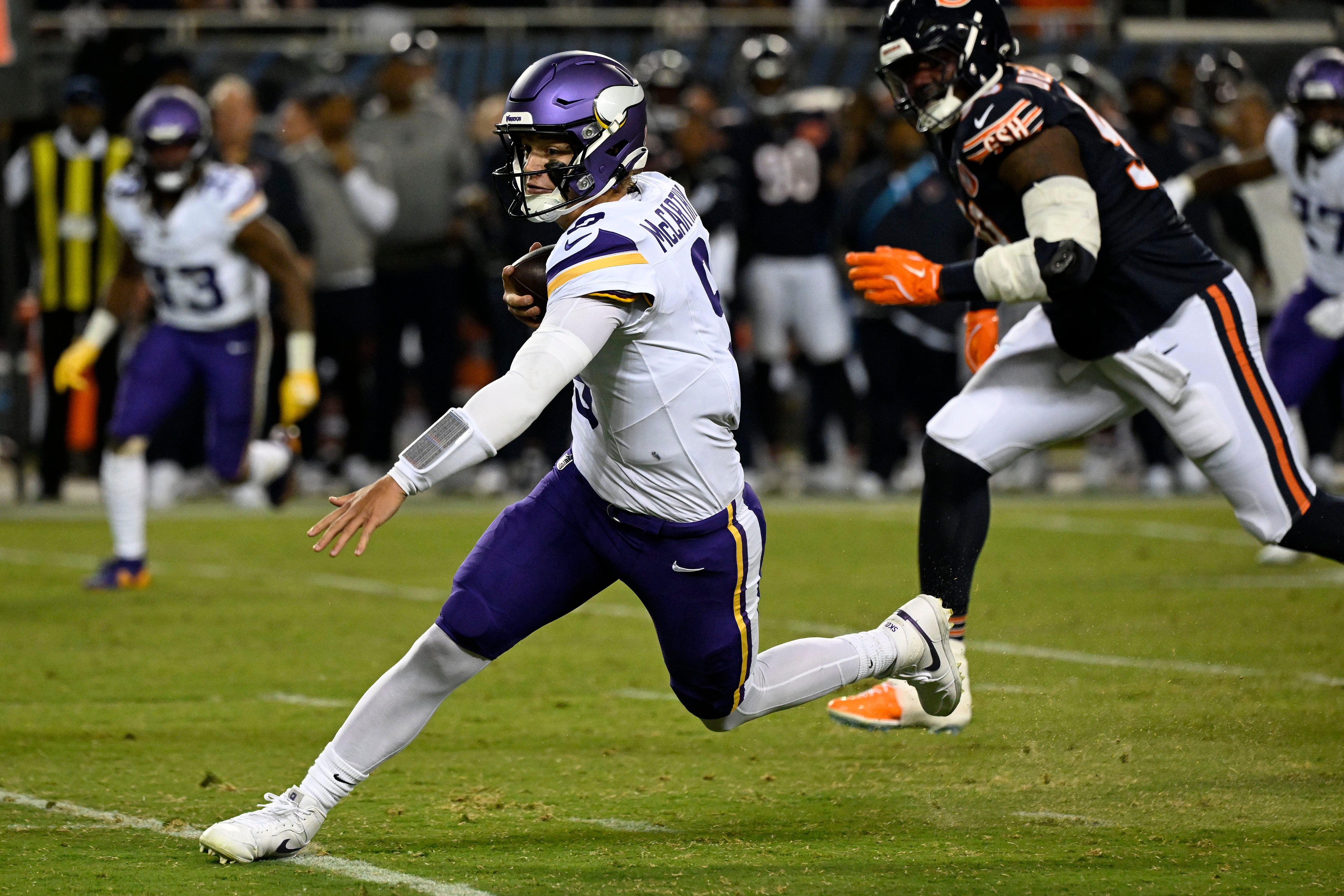 Sep 8, 2025; Chicago, Illinois, USA; Minnesota Vikings quarterback J.J. McCarthy (9) rushes the ball against the Chicago Bears during the first half at Soldier Field.