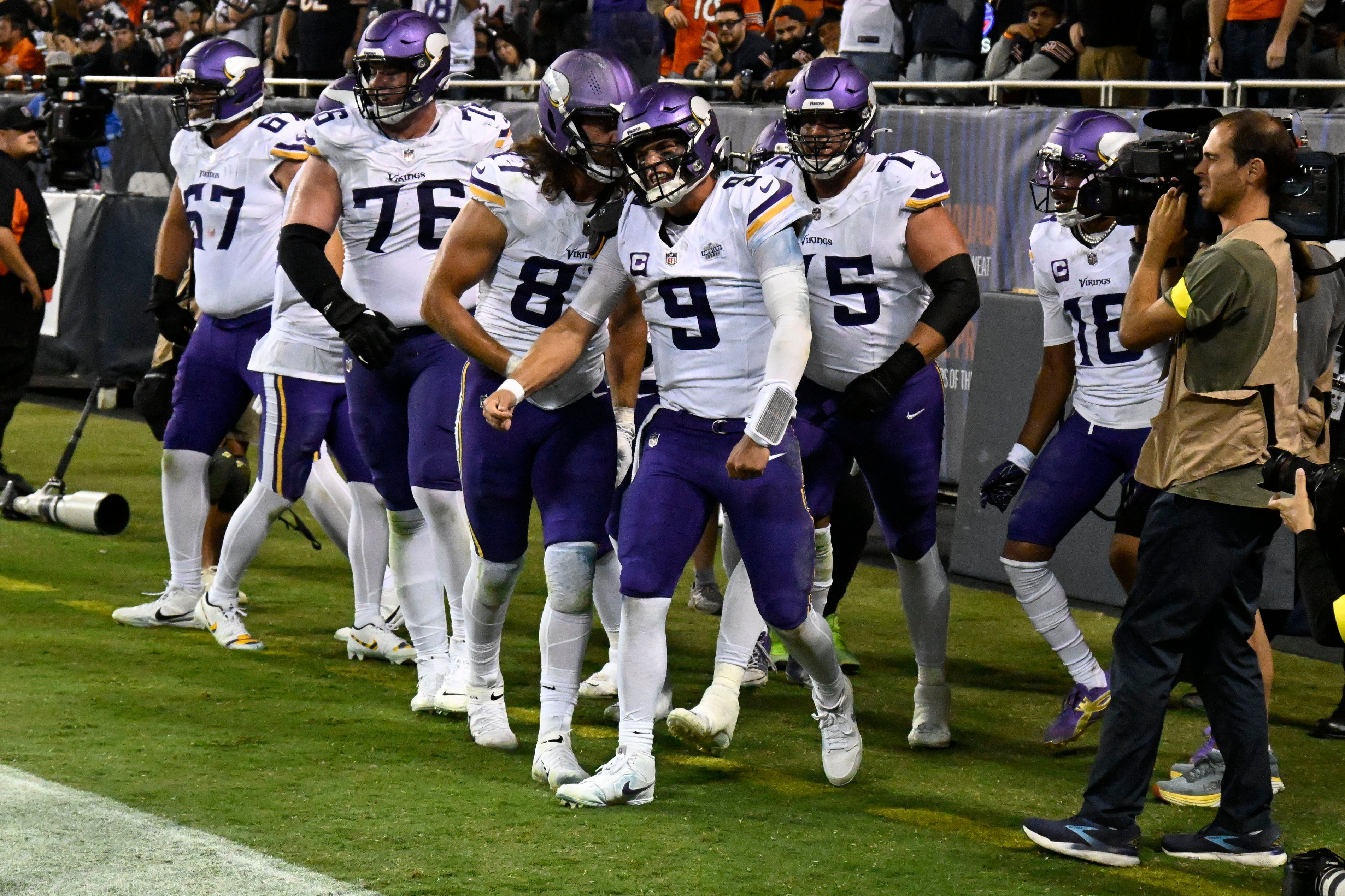 Sep 8, 2025; Chicago, Illinois, USA; Minnesota Vikings quarterback J.J. McCarthy (9) reacts after scoring a touchdown against the Chicago Bears during the second half at Soldier Field.