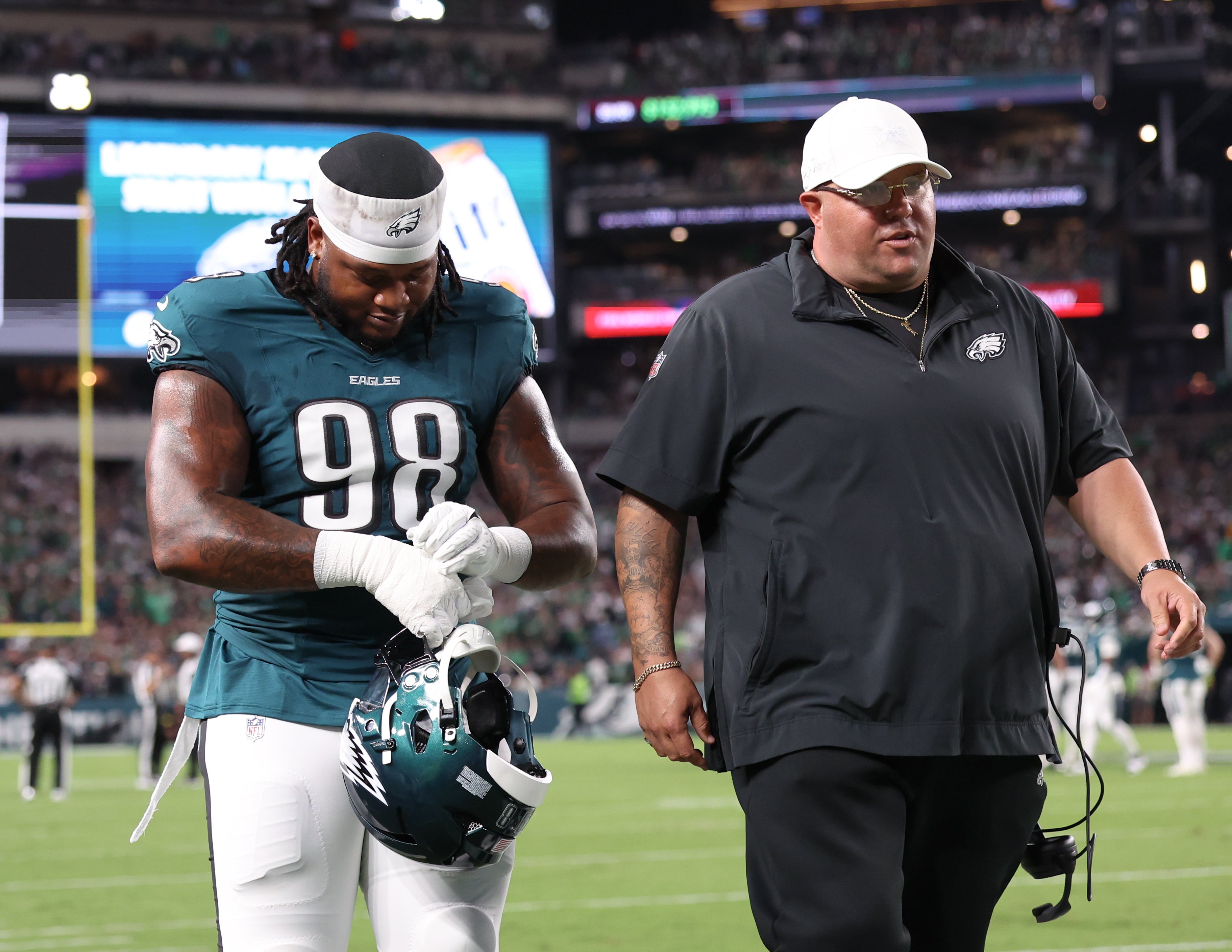 Philadelphia Eagles defensive tackle Jalen Carter (98) walks off the field with Eagles chief security officer Dom DiSandro (R) after being ejected from the game against the Dallas Cowboys at Lincoln F... Bill Streicher-Imagn Images