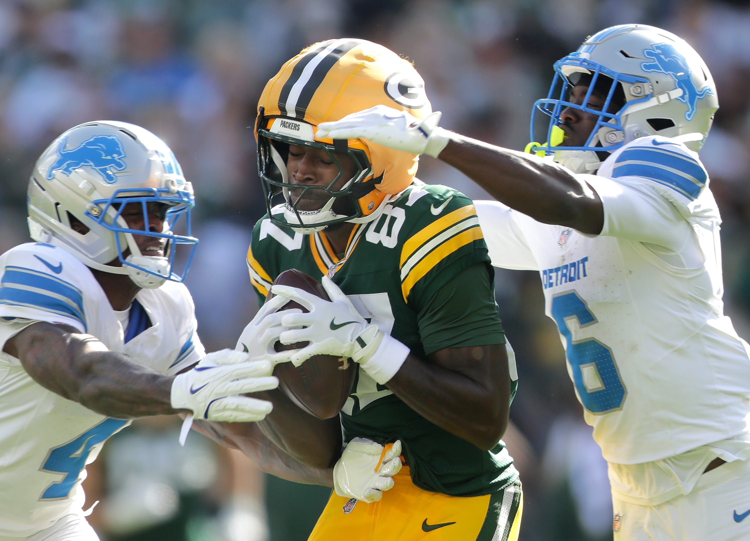 Green Bay Packers wide receiver Romeo Doubs catches a pass against Detroit Lions cornerback D.J. Reed (4) and cornerback Terrion Arnold (6) on Sunday, September 7, 2025, at Lambeau Field in Green Bay, Wis.