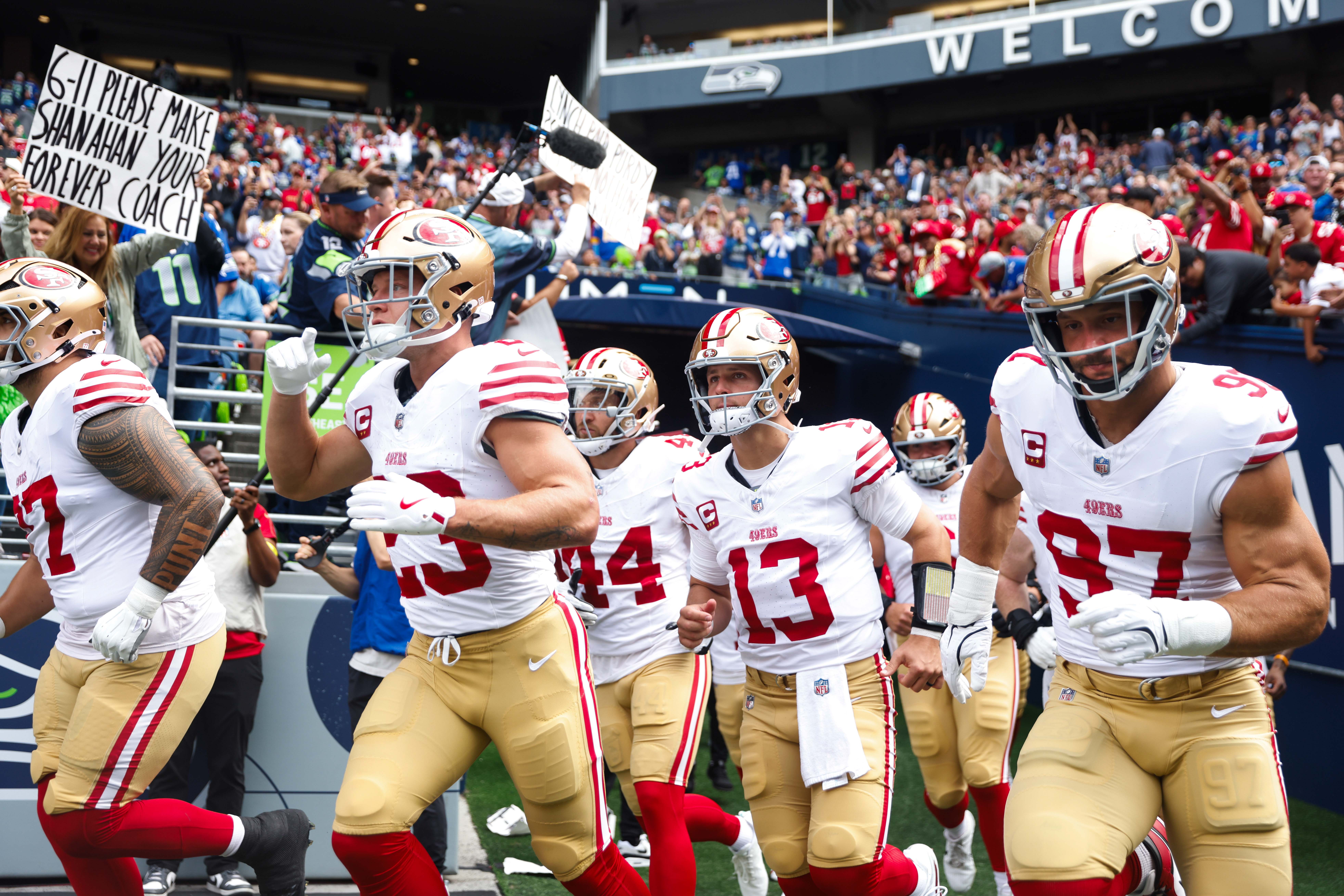 Sep 7, 2025; Seattle, Washington, USA; San Francisco 49ers running back Christian McCaffrey (23), fullback Kyle Juszczyk (44), quarterback Brock Purdy (13) and defensive end Nick Bosa (97) exit the locker room before the first quarter against the Seattle Seahawks at Lumen Field.