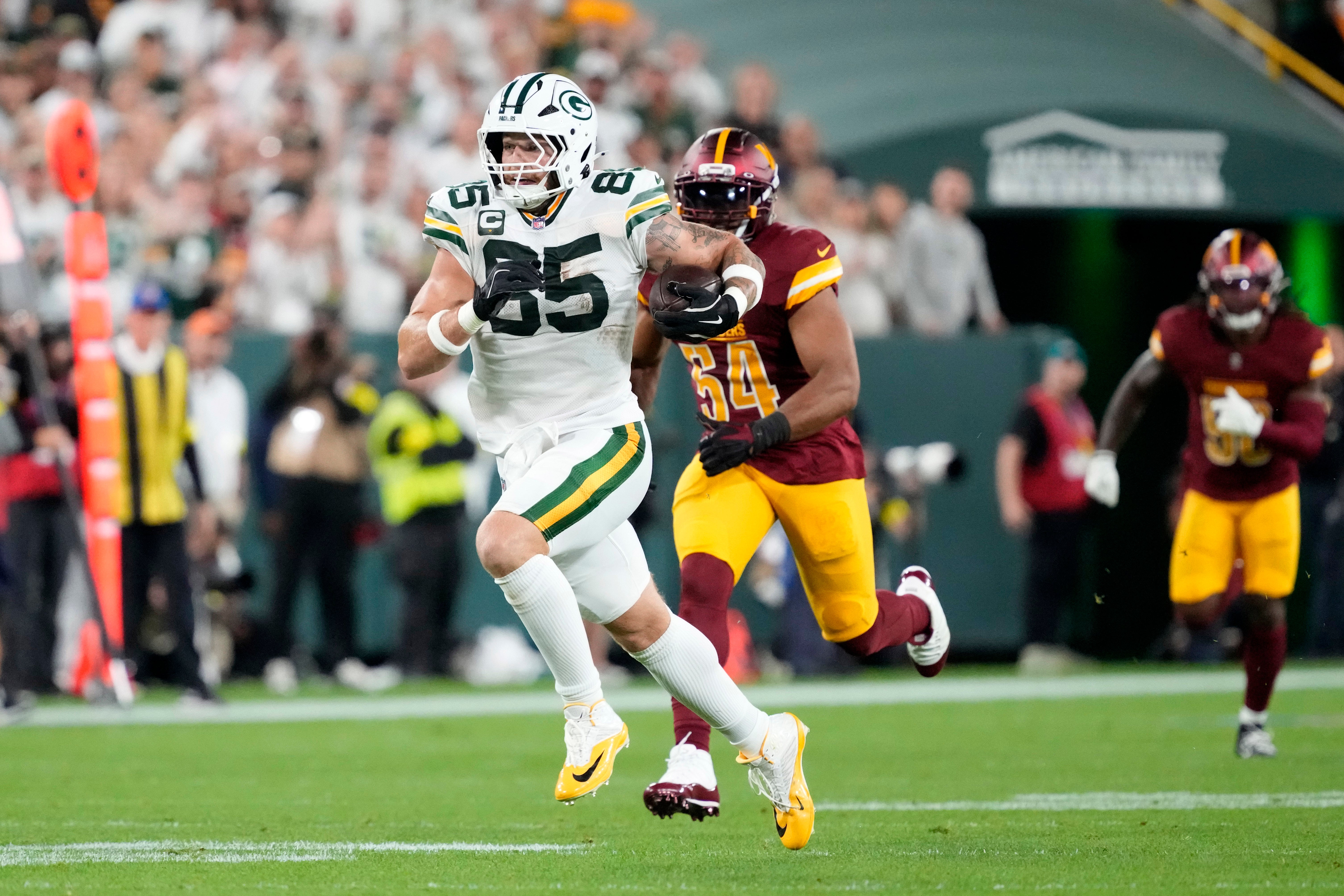 Sep 11, 2025; Green Bay, Wisconsin, USA; Green Bay Packers tight end Tucker Kraft (85) runs against the Washington Commanders in the first quarter at Lambeau Field.