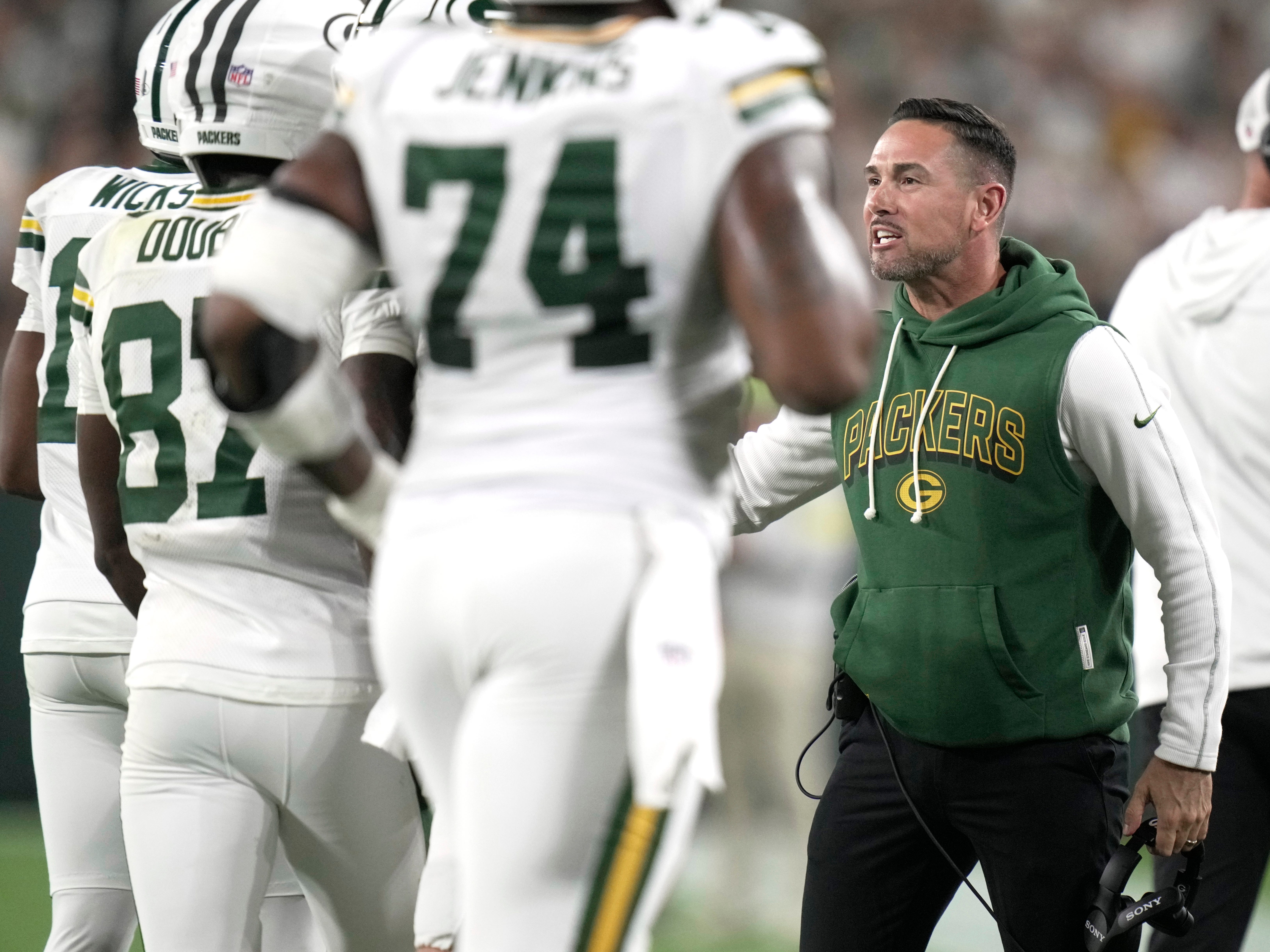 Green Bay Packers head coach Matt LaFleur congratulates wide receiver Romeo Doubs on his touchdown reception during the first quarter of their game against the Washington Commanders Thursday, September 11, 2025 at Lambeau Field in Green Bay, Wisconsin.