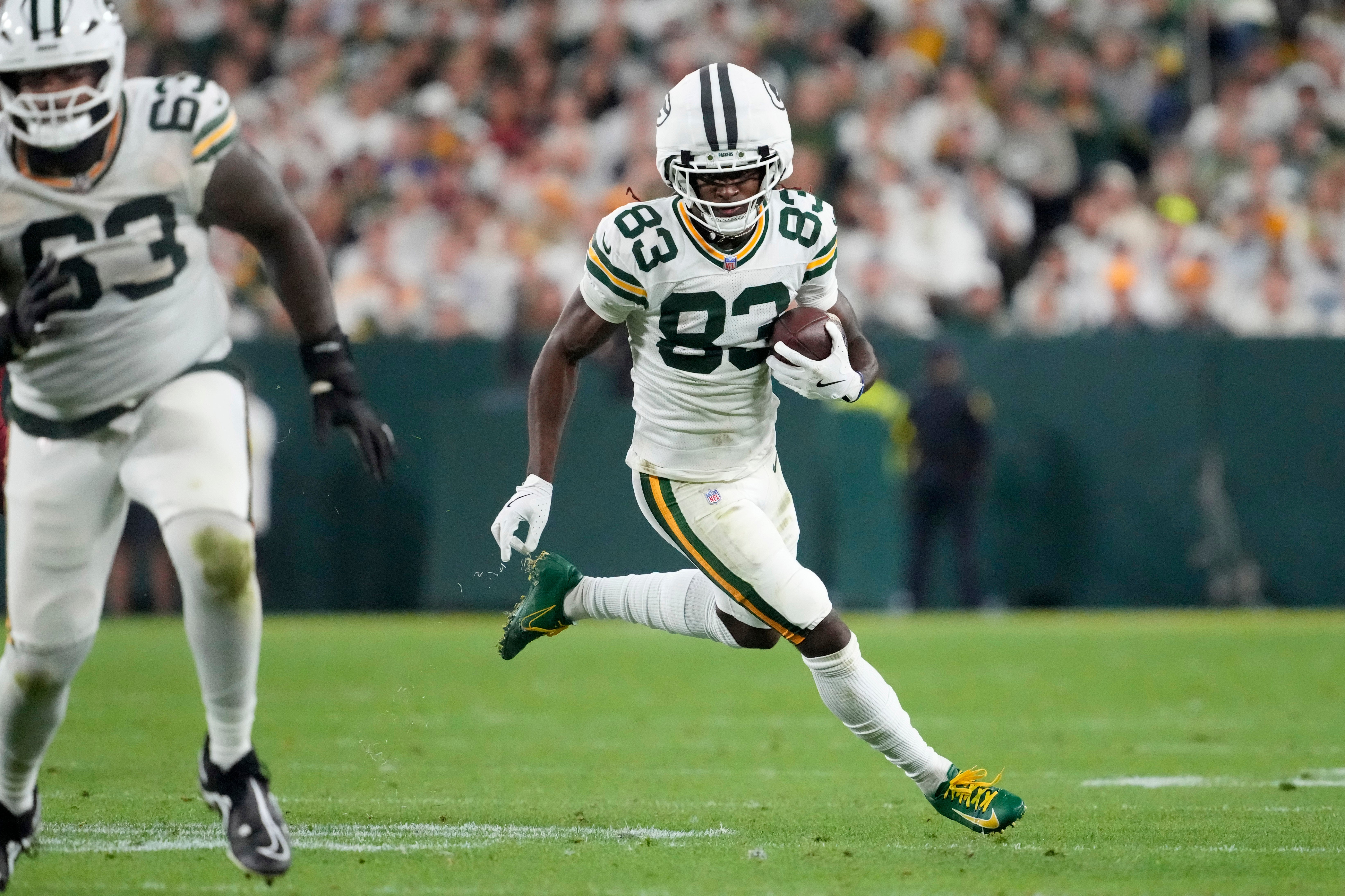 Sep 11, 2025; Green Bay, Wisconsin, USA; Green Bay Packers wide receiver Savion Williams (83) runs against the Washington Commanders in the fourth quarter at Lambeau Field.