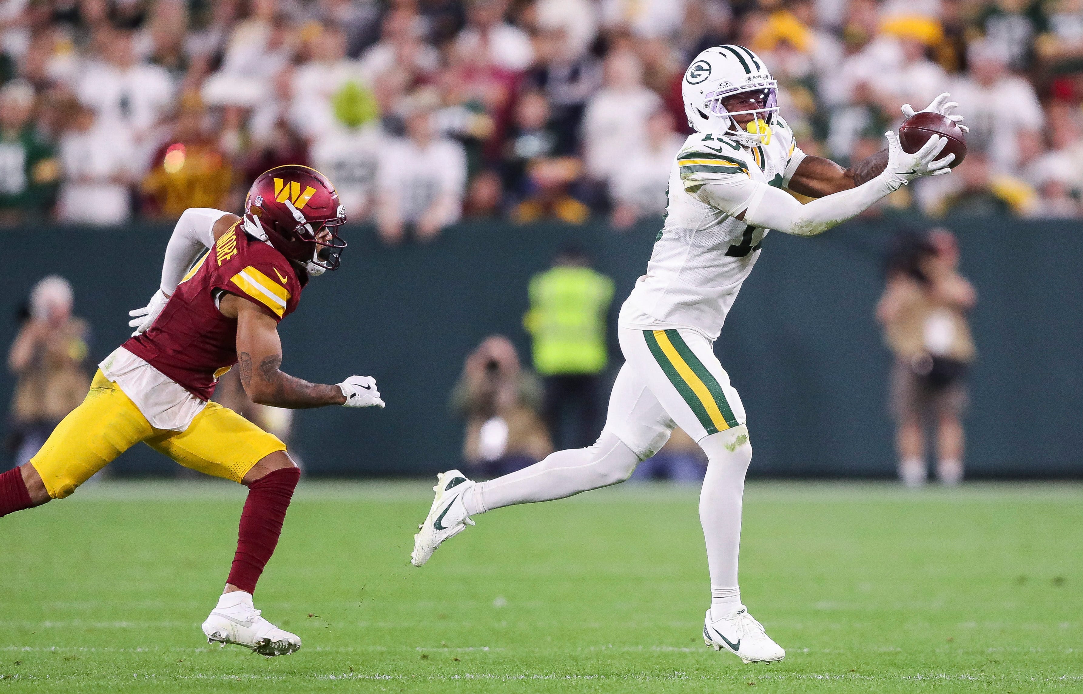 Green Bay Packers wide receiver Dontayvion Wicks (13) catches a pass against the Washington Commanders on Thursday, September 11, 2025, at Lambeau Field in Green Bay, Wis. The Packers won the game, 27-18.