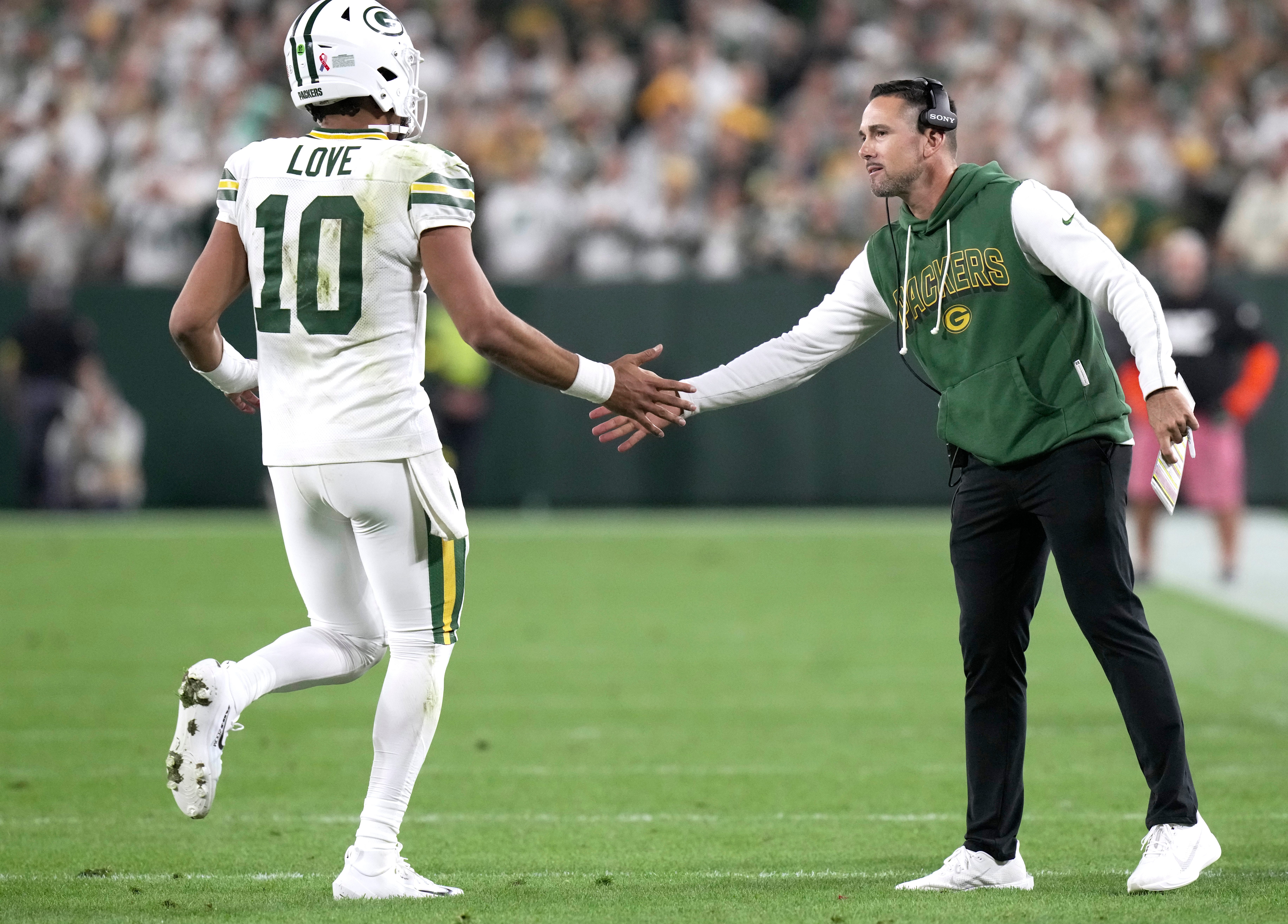 Green Bay Packers quarterback Jordan Love (10) in congratulated by head coach Matt LaFleur after throwing a touchdown pass during the fourth quarter of their game Thursday, September 11, 2025 at Lambeau Field in Green Bay, Wisconsin. The Green Bay Packers beat the Washington Commanders 27-18
