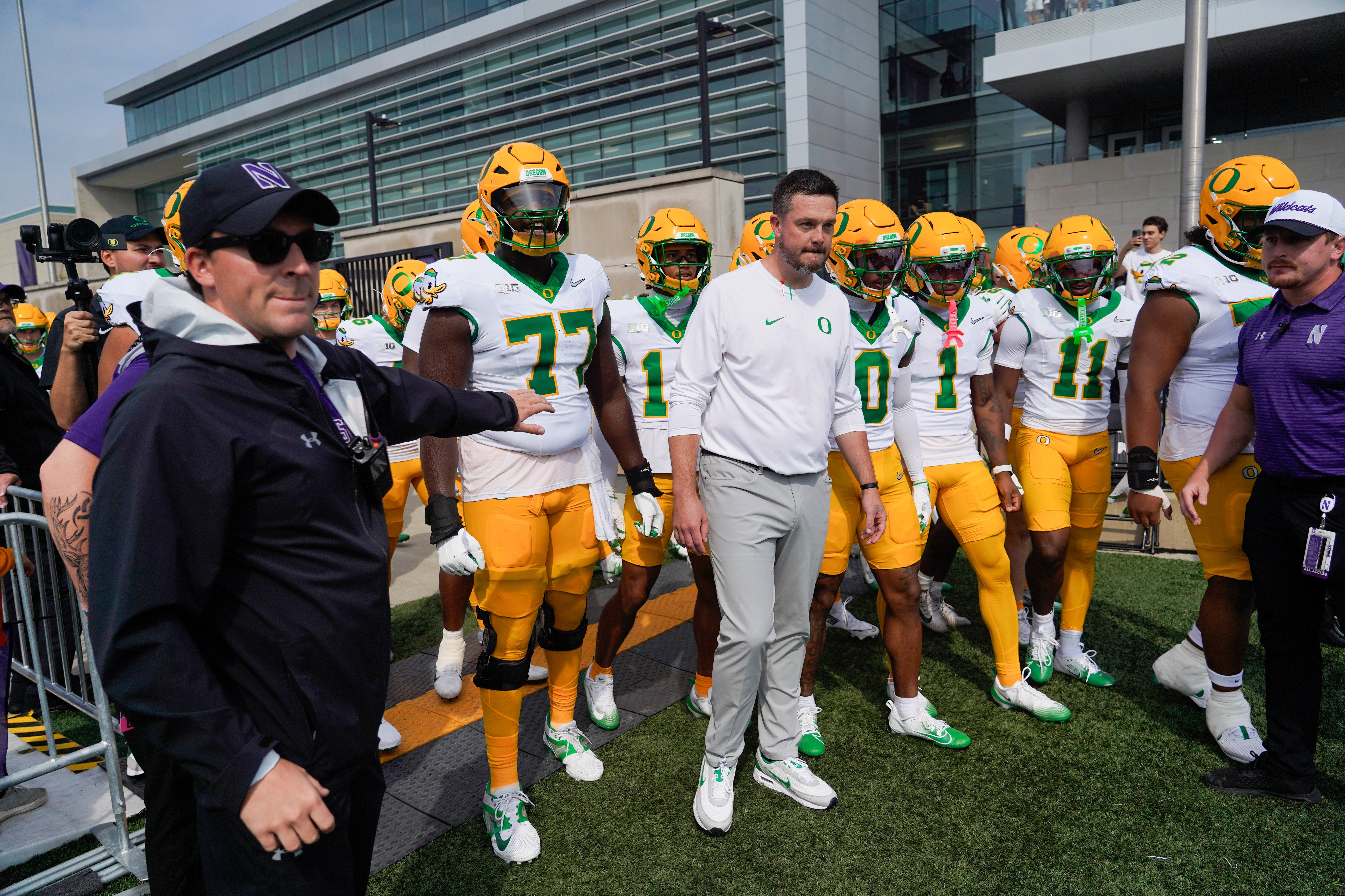Sep 13, 2025; Evanston, Illinois, USA; Oregon Ducks head coach Dan Lanning leads his team on the field against the Northwestern Wildcats at Northwestern Medicine Field at Martin Stadium. Mandatory Credit: David Banks-Imagn Images