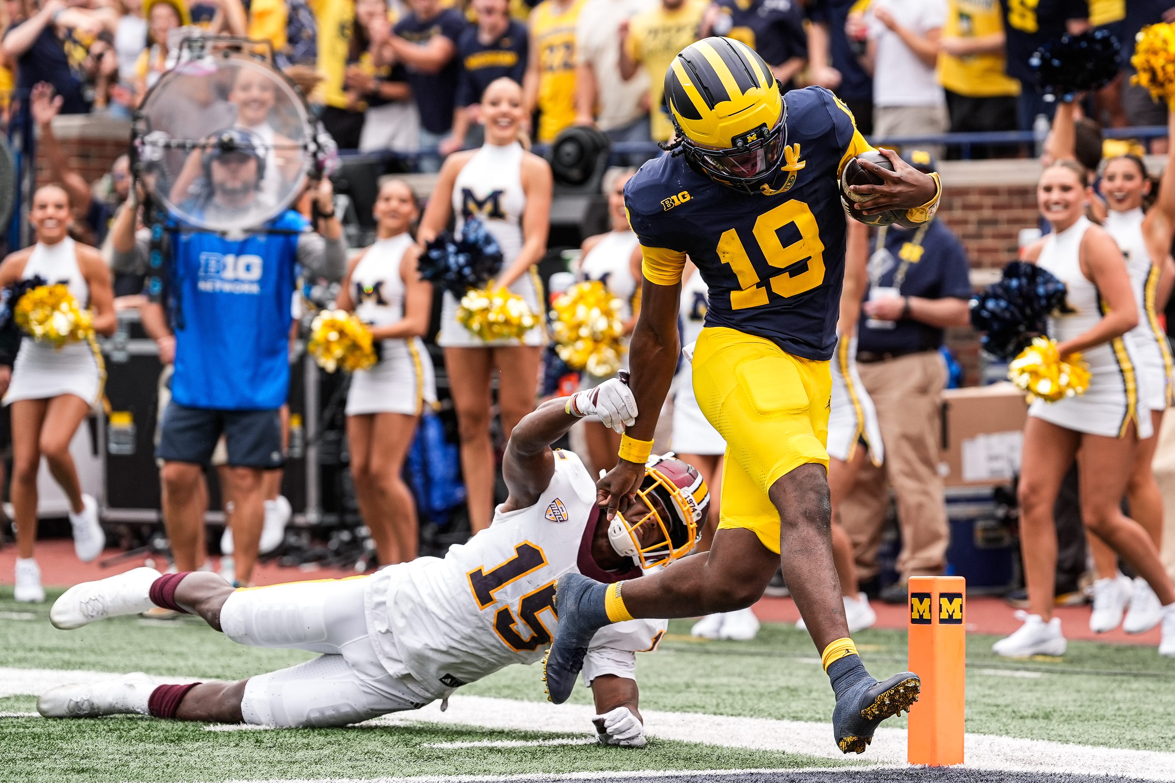 Michigan quarterback Bryce Underwood (19) runs for a touchdown against Central Michigan defensive back Caleb Spann (15) during the first half at Michigan Stadium in Ann Arbor on Saturday, Sept. 13, 2025.